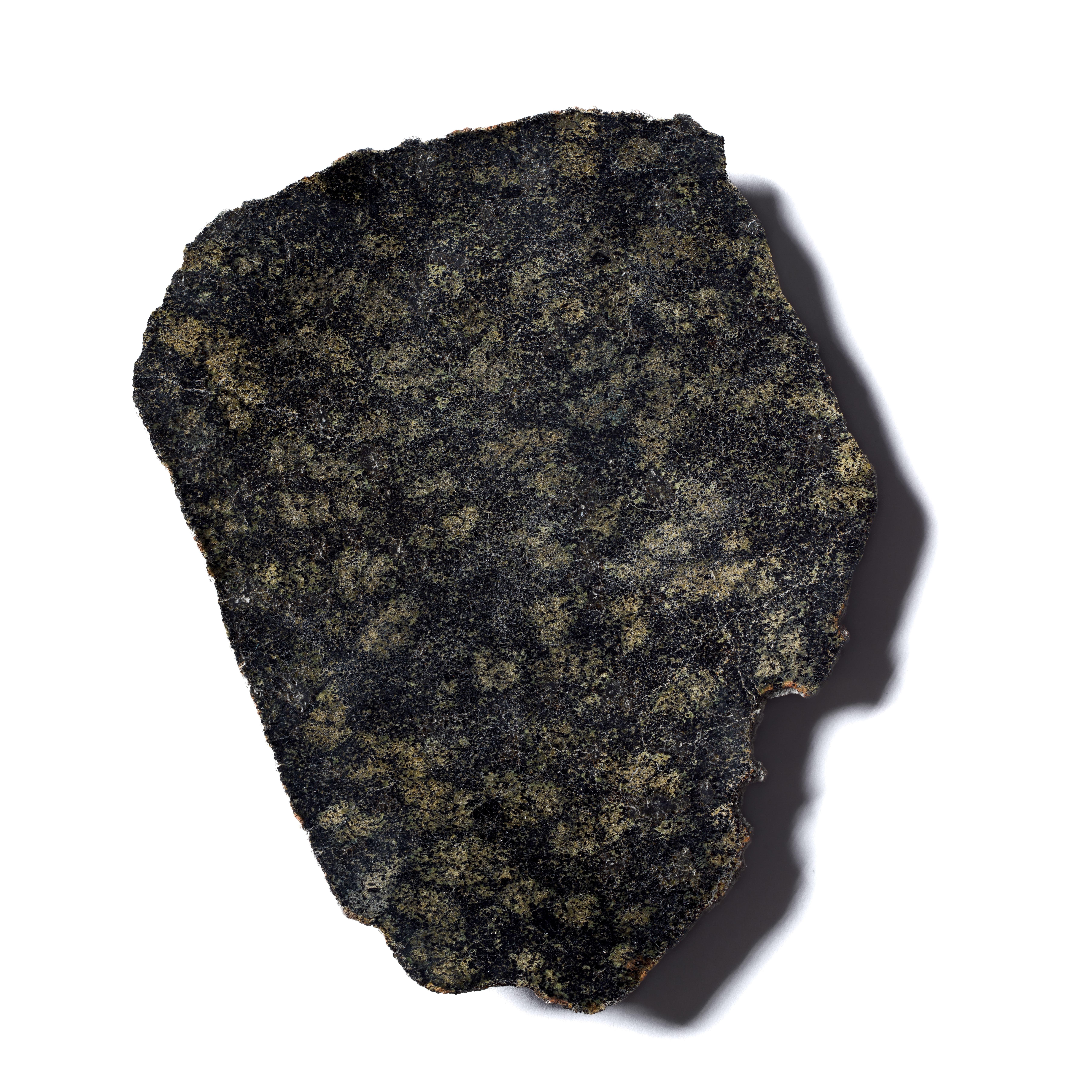 MARTIAN STONE - NWA 14713 
Lherzolitic shergottite 
127 g 

“This 127-gram fragment of the NWA 14713 meteorite displays a green-black mottled exterior. The rock is a martian shergottite (a basalt) composed mainly of coarse grains of pyroxene as well