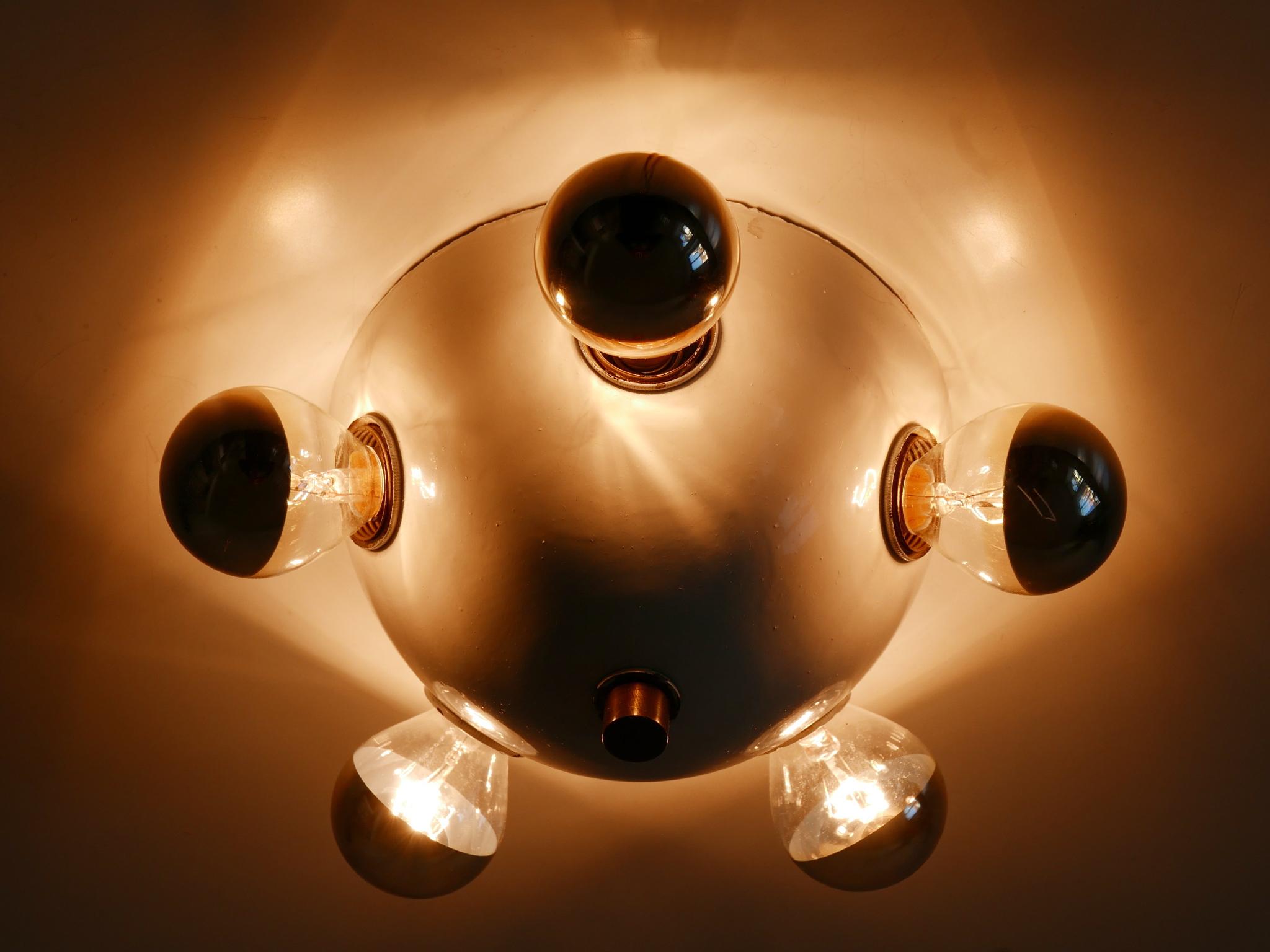 Extremely rare and highly decorative Mid-Century Modern five-flamed sconce or ceiling lamp. Designed & manufactured in Germany, 1960s.

Executed in white enameled sheet metal and brass, the fixture comes with 5 x E14 / E12 Edison screw fit bulb