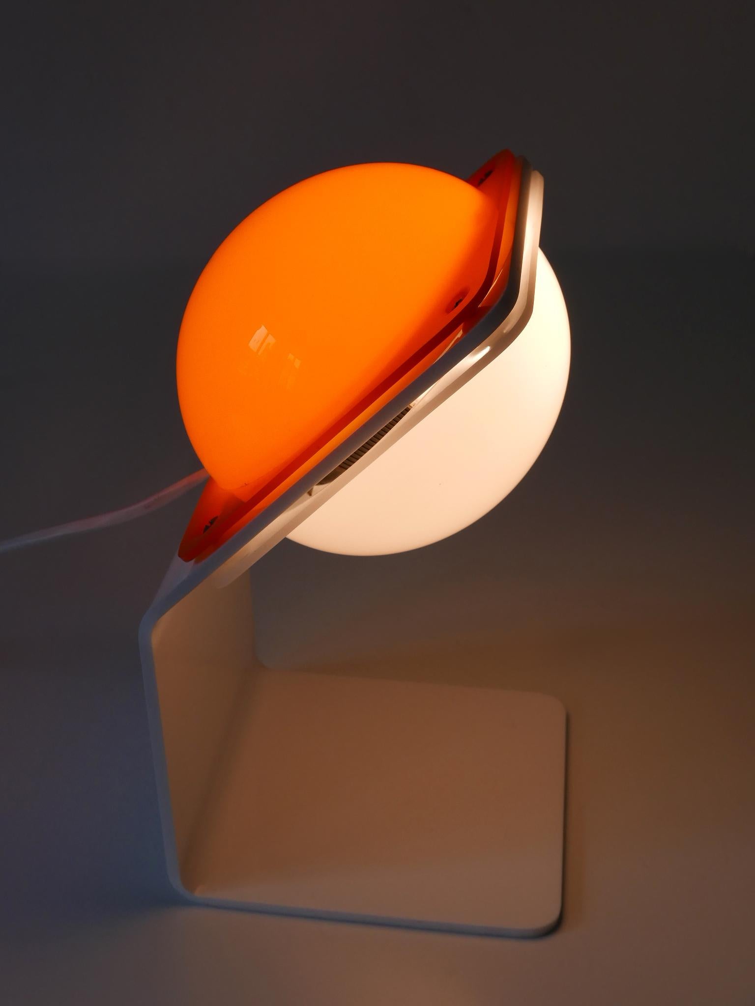 Extremely rare, elegant and highly decorative Mid-Century Modern lucite table lamp. Designed and manufactured by Harvey Guzzini, Italy, 1970s.

Executed in white and orange lucite, the lamp comes with 1 x E14 / E12 Edison screw fit bulb socket, is