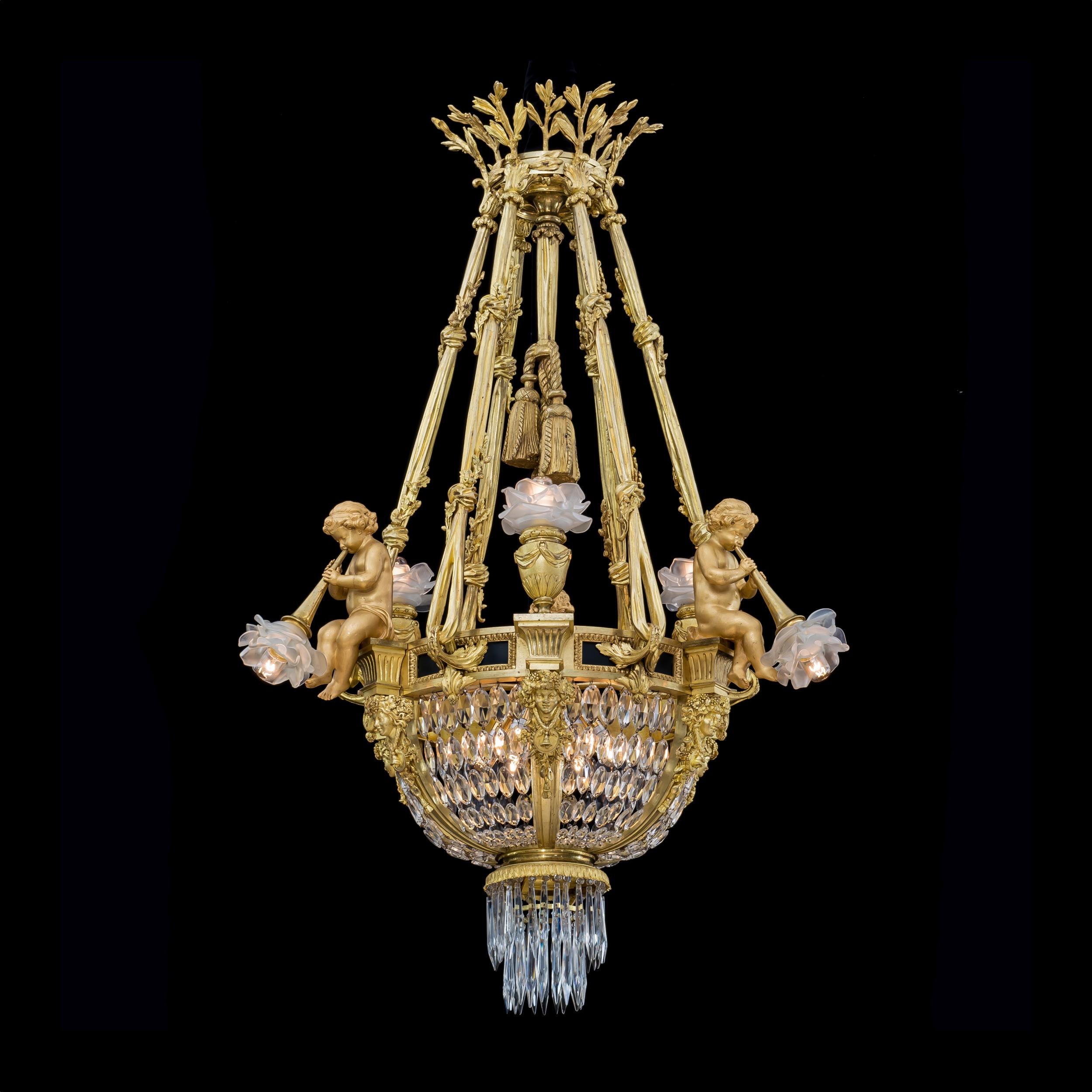 An important pair of ormolu basket chandeliers
In the Louis XVI style

Constructed from gilded bronze of the finest quality with clear crystal cut drops and cascading beads, the pair of chandeliers of rounded basket shape suspended from six