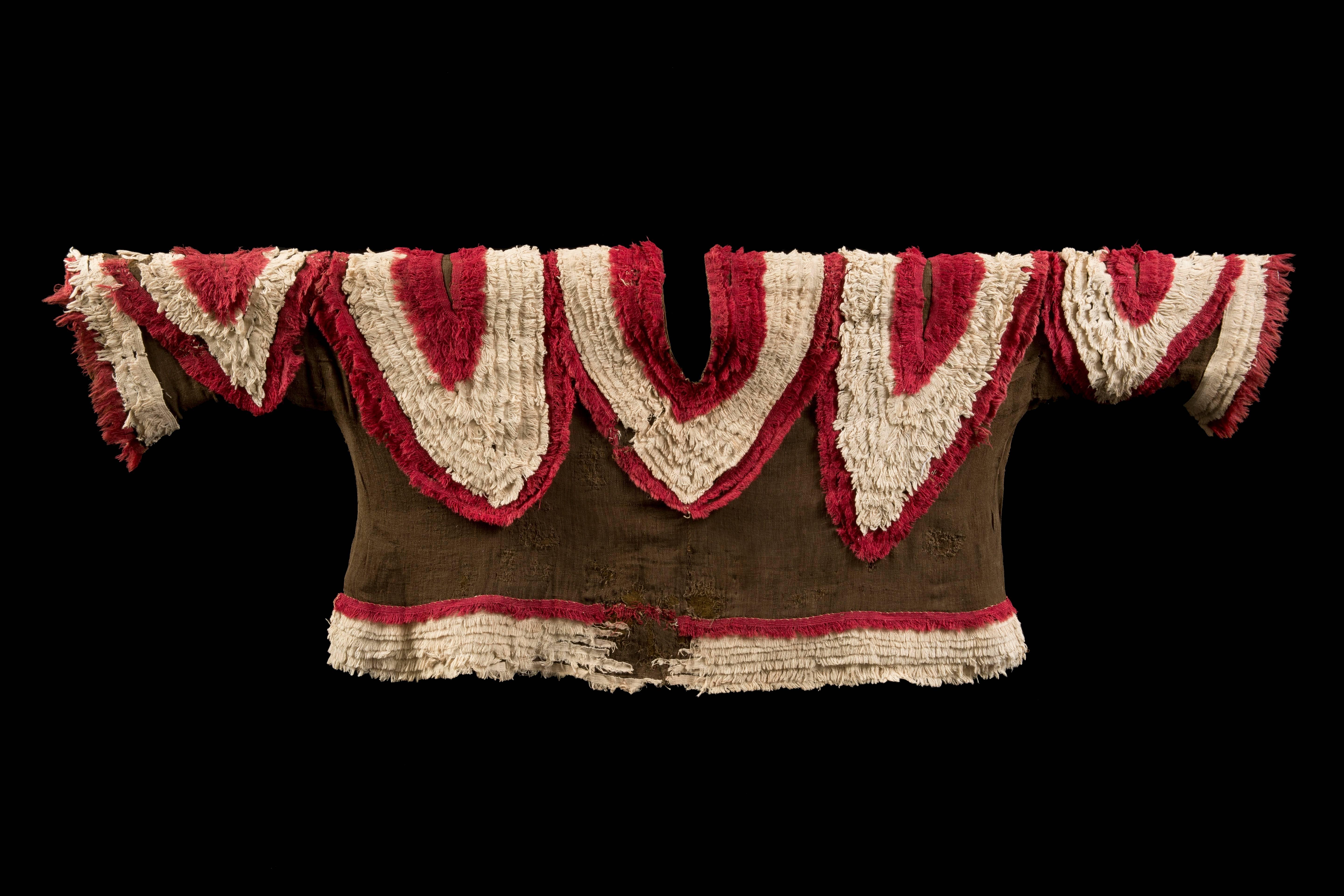 Chimu brown gauze shirt with multiple red and white fringe lines forming V designs like the one around the neck, with very rarely seen sleeves and border fringe in the same material.