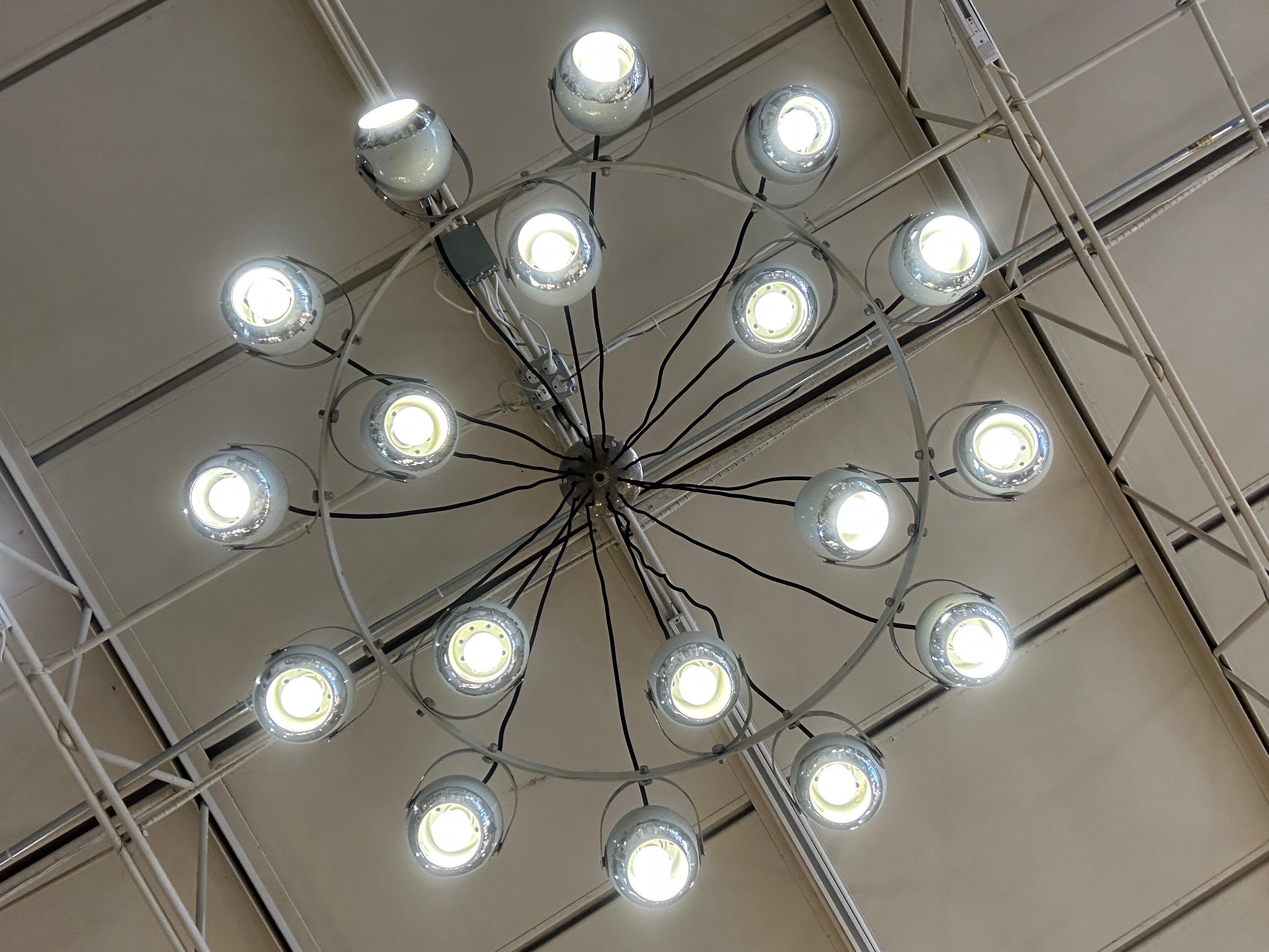 Made up of 18 articulating orbs in white and chrome, they hand from 18 black thread cables and original canopy. This is a RARE Stilnovo chandelier! Many of the orbs retain original Stilnovo labels to interior.  THIS ITEM IS LOCATED AND WILL SHIP