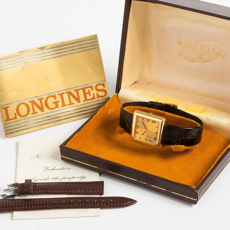 Our extremely rare vintage Longines features an 18k yellow gold case of 29mm x 30mm , chequer board dial and leather strap with gold tone buckle. Included with this example comes its original box, original open / blank papers as well as a valuation