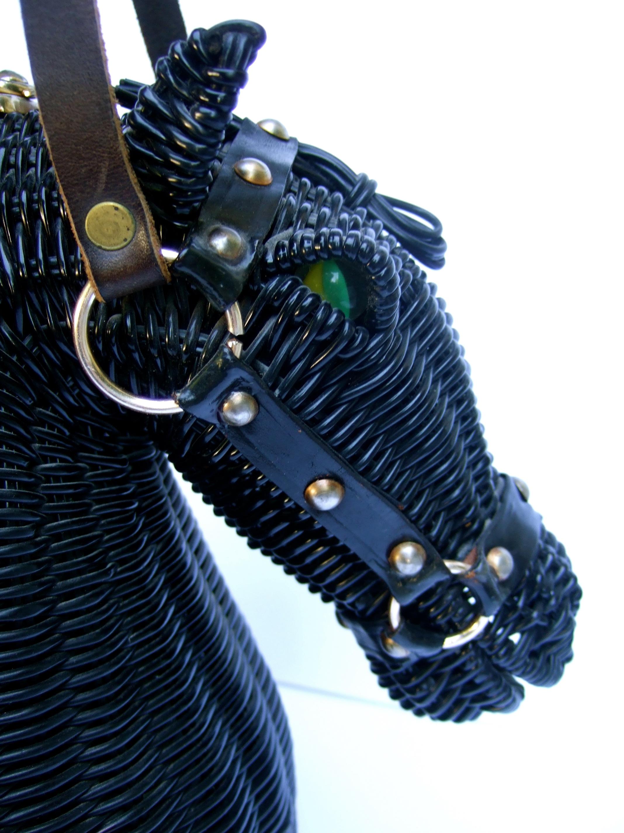 Extremely rare 1970s woven black vinyl horse head handbag designed by Marcus Brothers 
The incredible three dimensional handbag is designed with structured vinyl woven bands 
Adorned with fiery glass marble eyes. One eye is green & yellow. The other