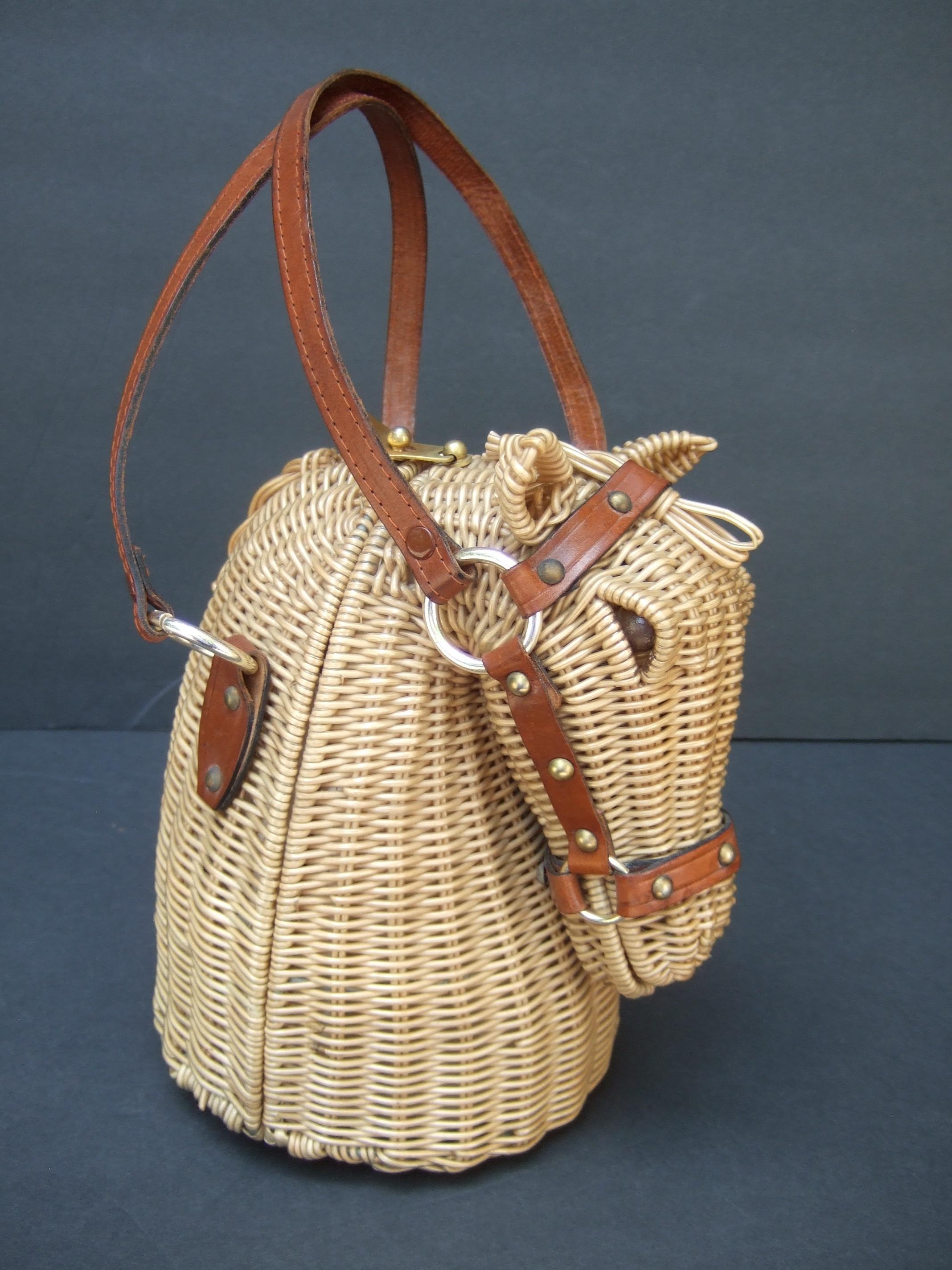 Extremely rare wicker rattan equine horse head handbag designed by Marcus Brothers c 1970
The three dimensional wicker rattan horse head is designed with woven wicker rattan bands
The glass marble eyes are distinguished with brown enamel