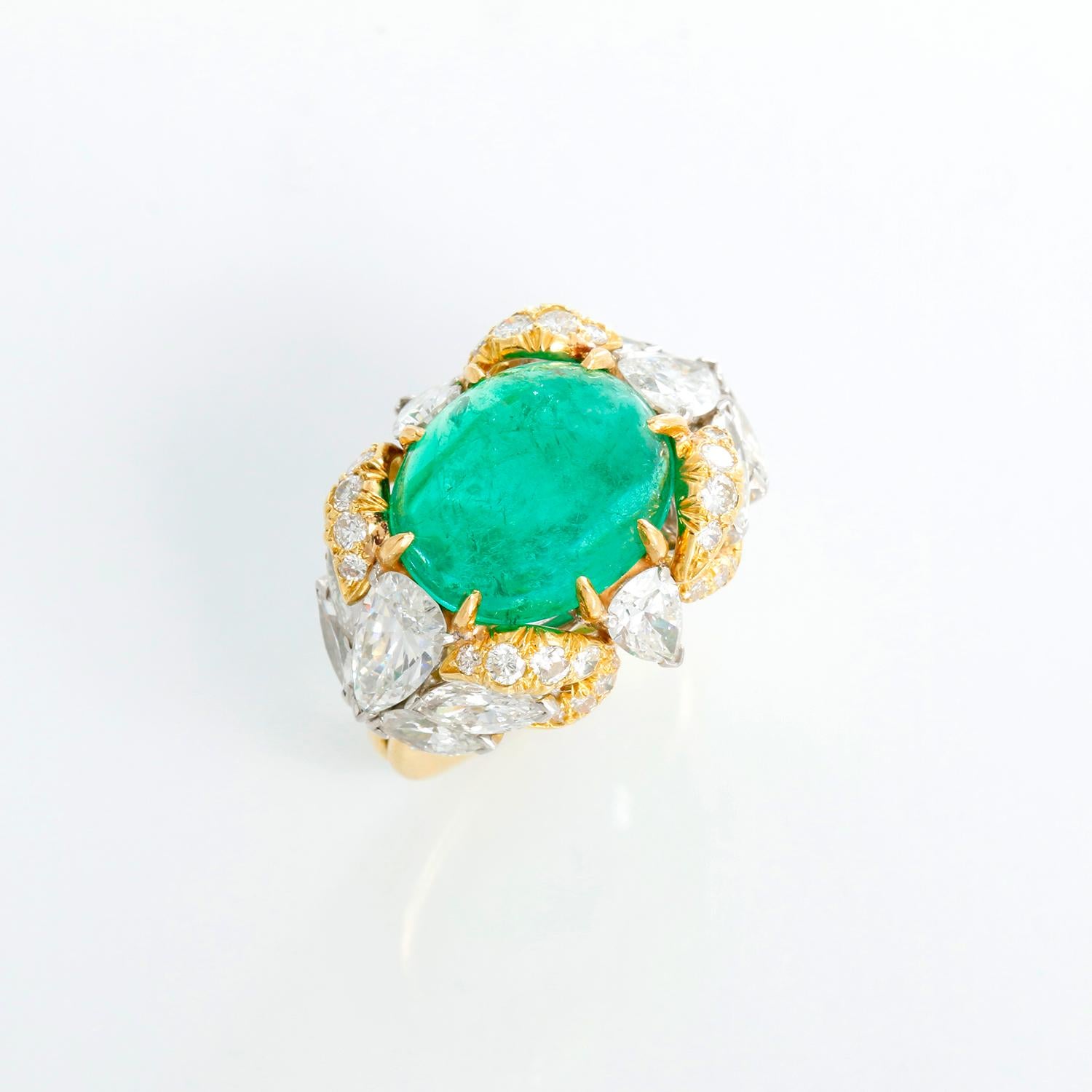 Extremely Unique Cabochon Emerald & Diamond Ring Size 6.5 - An extremely unique Cabochon Emerald weighing 7.30 cts. Originally from Colombia set in 18K yellow gold. Surrounded by 2 pear diamonds weighing approx. 1.40 cts ( H, VS2) , 8 marquis
