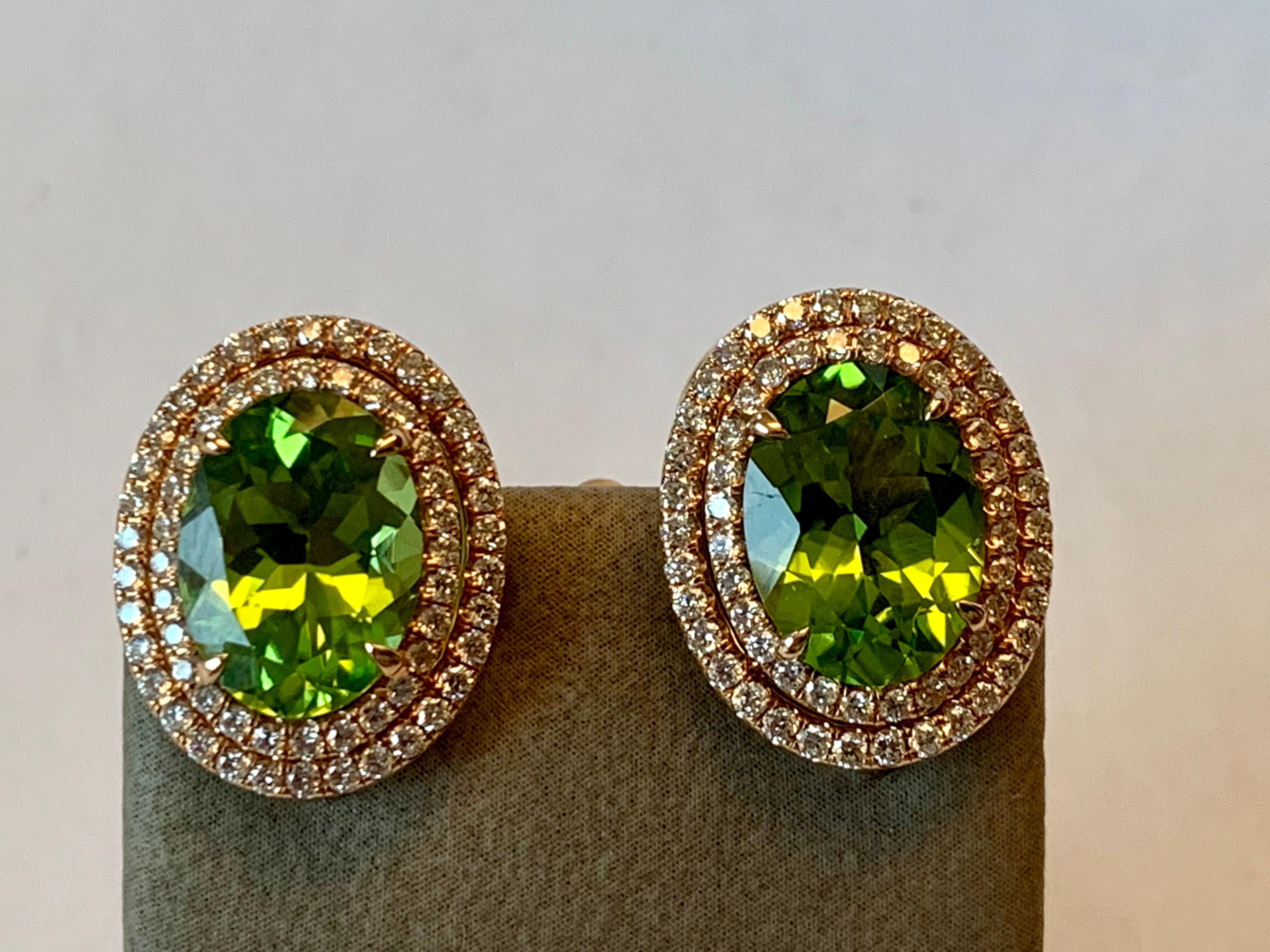 Vivid green Peridots with a total weight of 7.73 ct in a double row diamonds setting. 124 brilliant cut Diamonds weighting 1.11 ct, G color, vs clarity. Hook device on ear studs where you can hang additional pendants such as pearls etc. 
