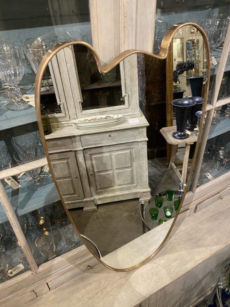 Eye catching Italian brass mirror from the 1950s, with a stunning fun and unusual form. (Teddy bear or Mickey Mouse?) The mirror glass is original and the mirror is related stylistically to the mid-century designer Giò Ponti.

The ideal mirror for