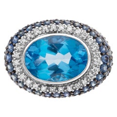 Eye Catching Cocktail Ring, 7 Carat Oval Cut Blue Topaz Surrounded by Blue