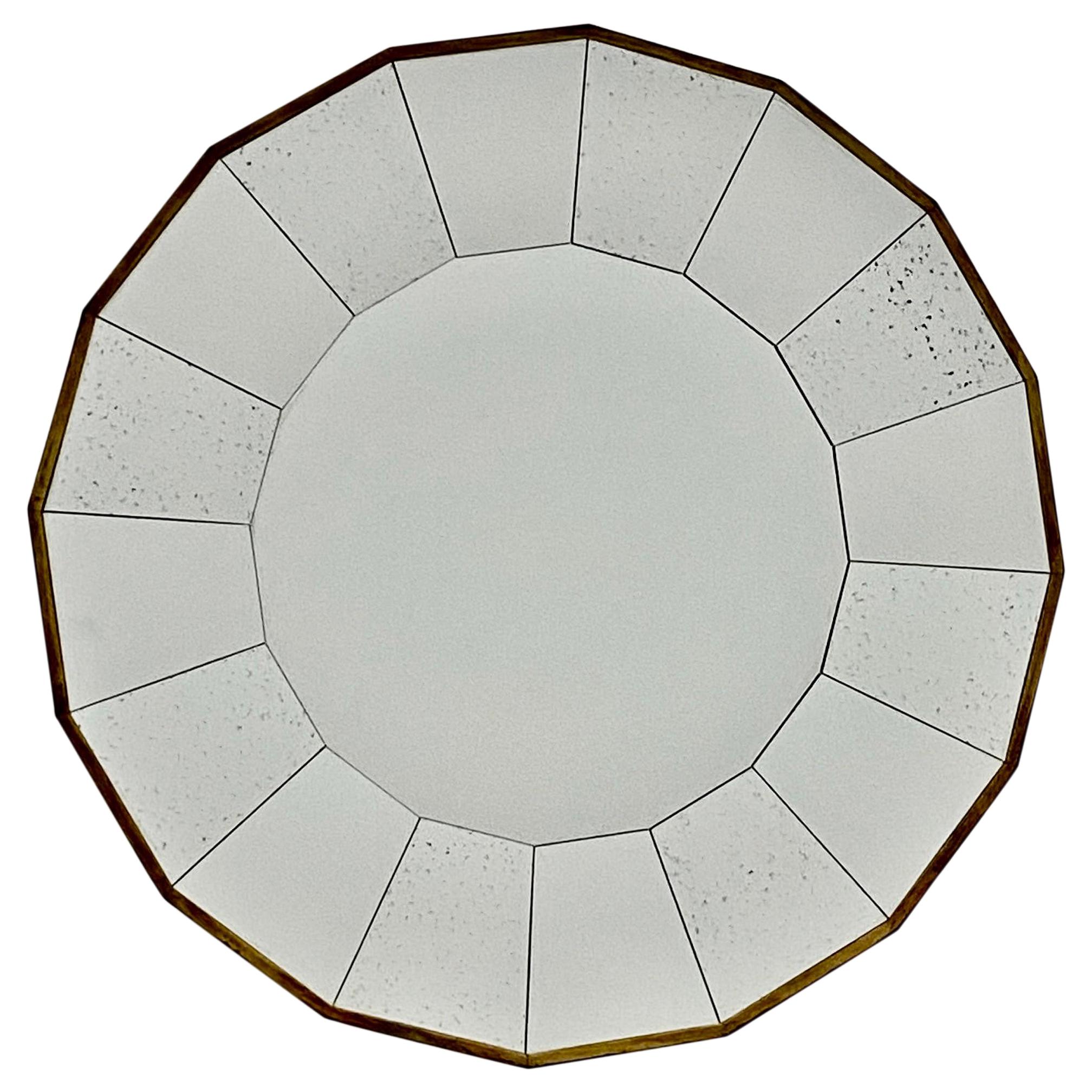 A pair of cool scalloped mirrors with a starburst design consisting of aged mirror set in a dark frame highlighted with gold.