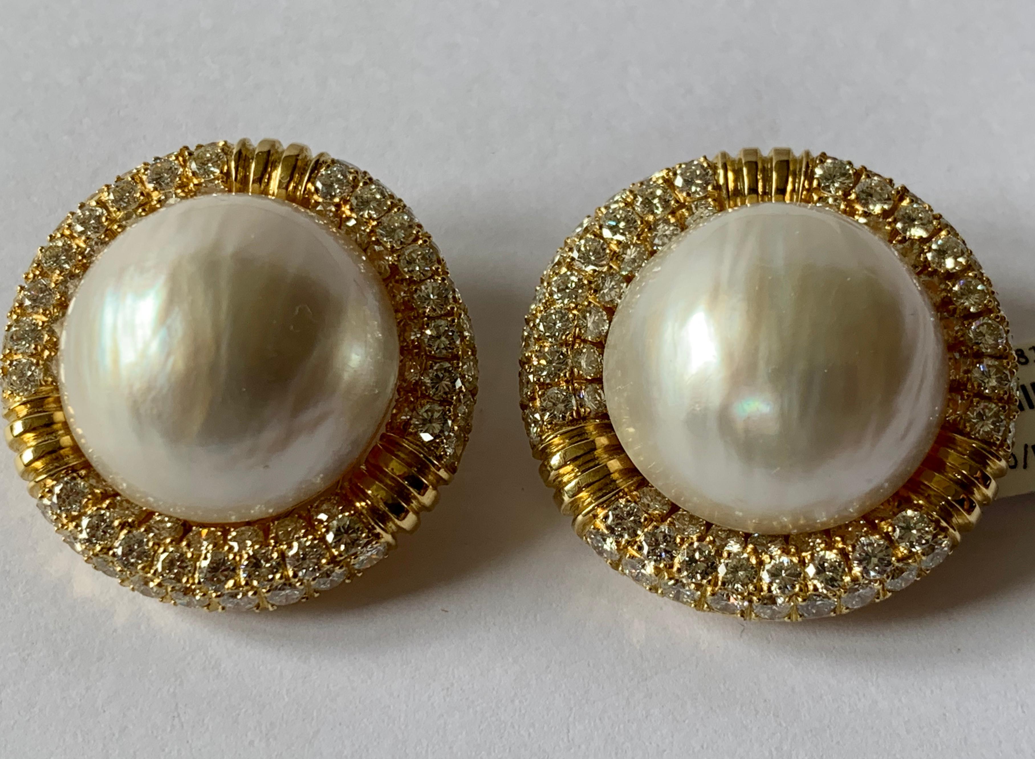 These large 18 K yellow gold clip earrings feature two mabe pearls that measure almost 2 cm in diameter and are accented with 150 round diamonds with an approximate total weight of 3.50 ct, G color, vs clarity. IF needed, post can be added to wear
