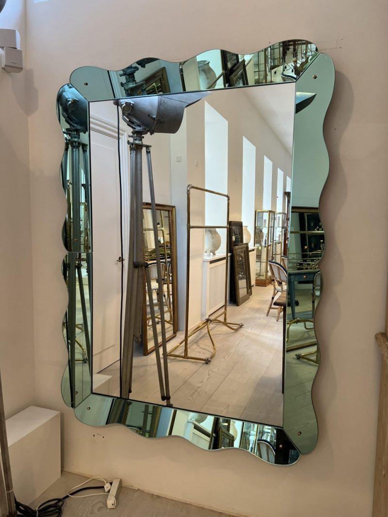 Absolutely fantastic retro mirror, from Italy of the 1970s. Hardwood frame with the original stunning wave formed mirror panelling.

A handsome and large looker.

Just the statement for any space, especially a bathroom, entrance or walk in.