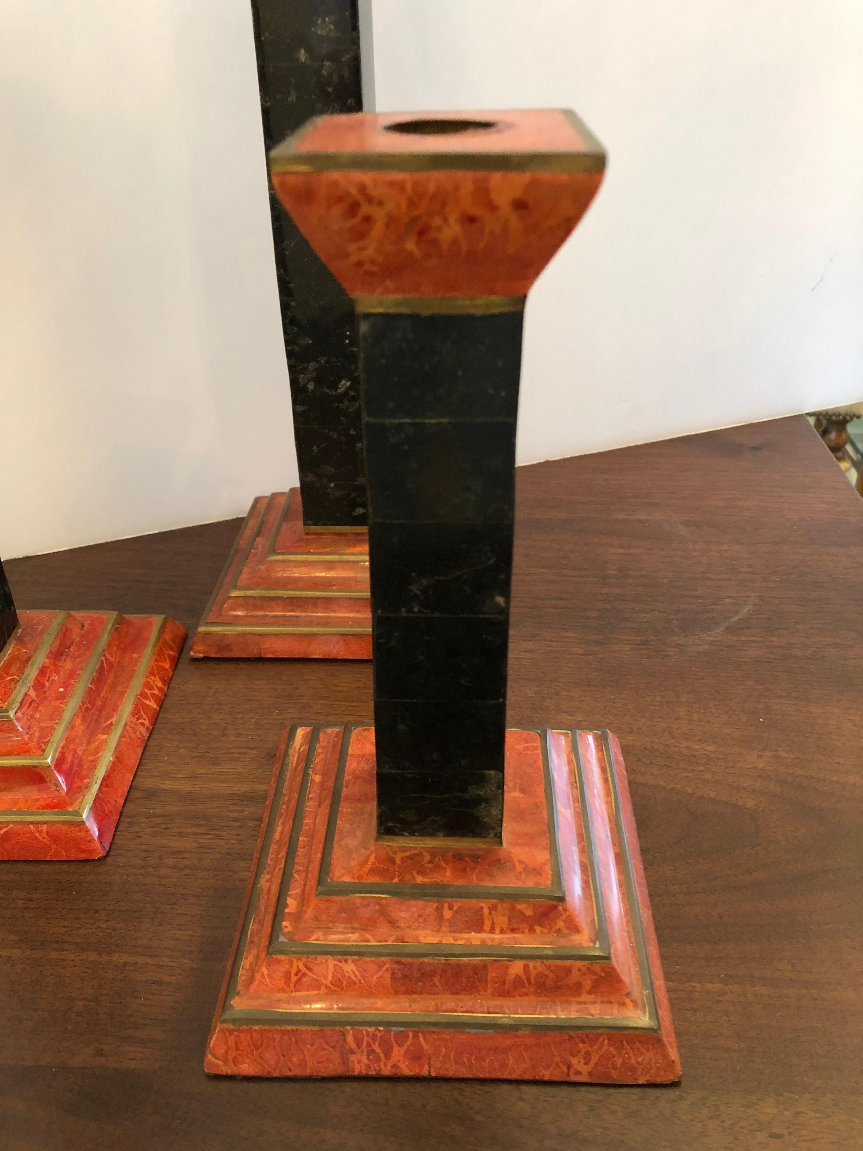 Great looking trio of burnt orange and dark green marble candlesticks with brass decoration. 9 inches high, 12 inches and 15 inches
5 inches square base.