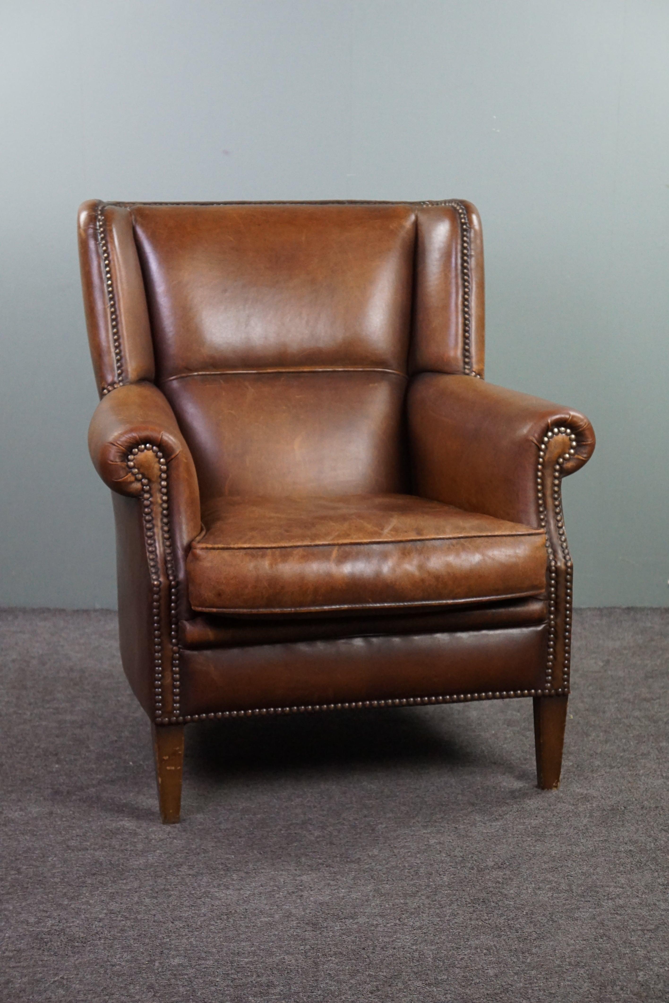With pride we offer you this beautiful sheep leather wingchair in a stunning color scheme!

This wingchair with a distinctive appearance features a beautiful variety of colors in the sheep leather. Through use, this chair has acquired a lovely