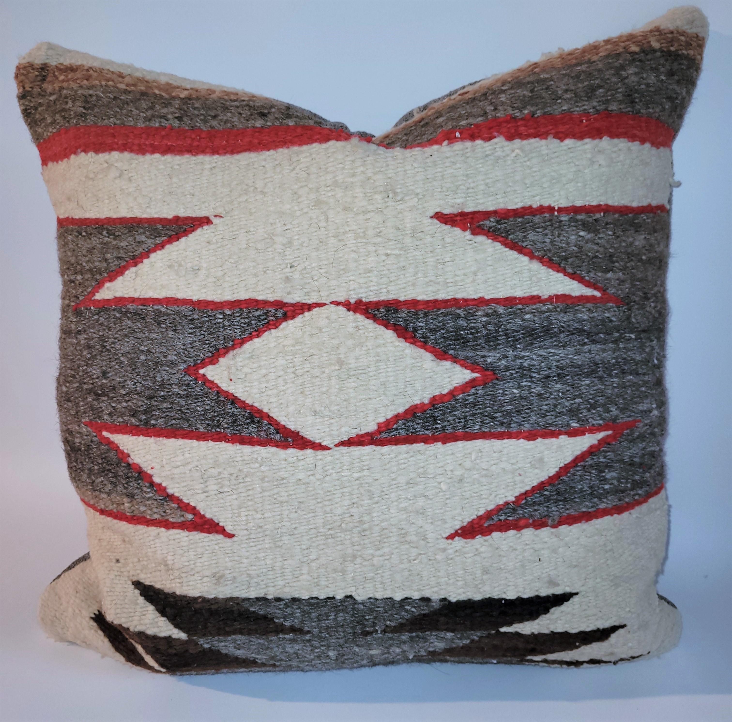 Custom made from a vintage Eye Dazzler Navajo rug. Pillow has a feather and down insert and a zippered case.