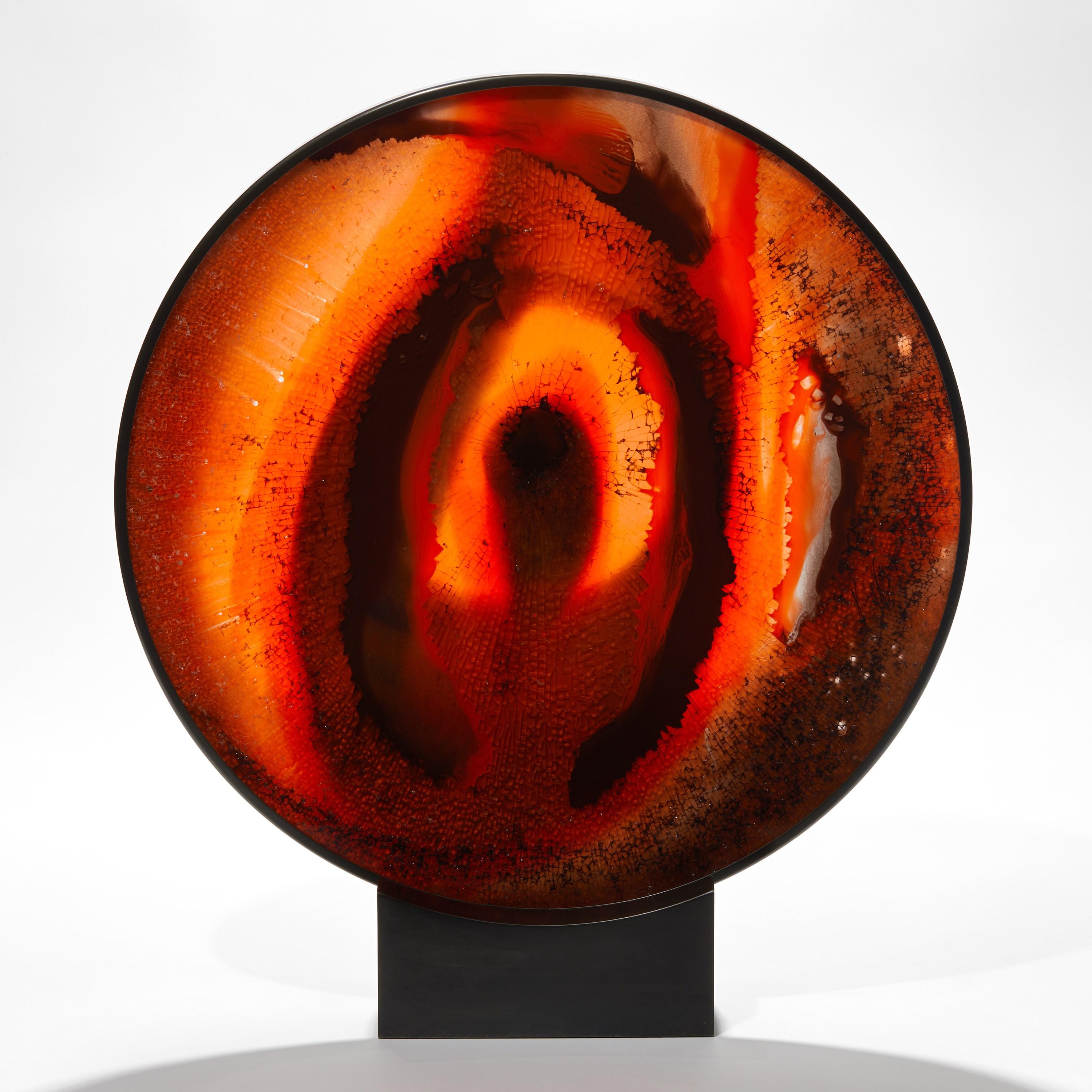 ‘Eye of Bravery’ is a unique sculpture by the Cypriot artist, Yorgos Papadopoulos, created from glass, silicone and fluorescent pigments with a hematite patinated steel bezel and stand.

Papadopoulos has reworked the iconic 'Evil Eye' amulet with