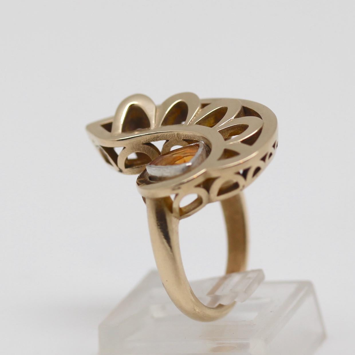 The protective Eye of Horus sits atop your finger in this sculptural ring.  Fascinating to touch and to study, this design spirals like a staircase.  Printed in a brass/bronze alloy that doesn't tarnish or discolor your finger. Sterling bezel-set