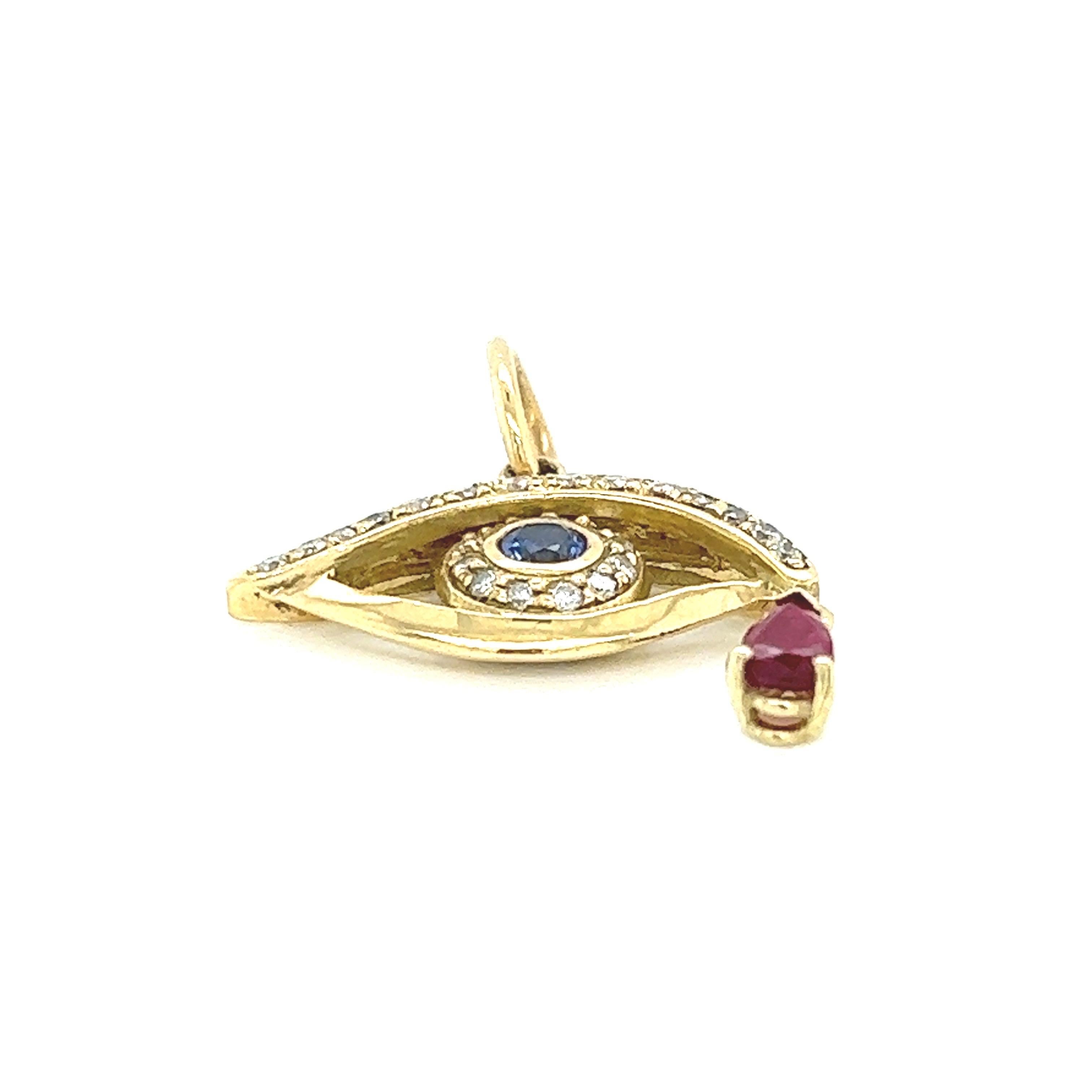 Lois D. Sasson Design

This stunning eye pendant is a masterpiece crafted in 18k yellow gold, exuding timeless elegance and luxury. The pendant features a beautiful faceted Ceylon sapphire, approximately 0.15 carats, at its center, symbolizing