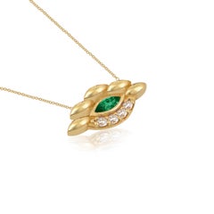 Ciondolo a forma di occhio in oro giallo 18 carati con diamanti e smeraldo