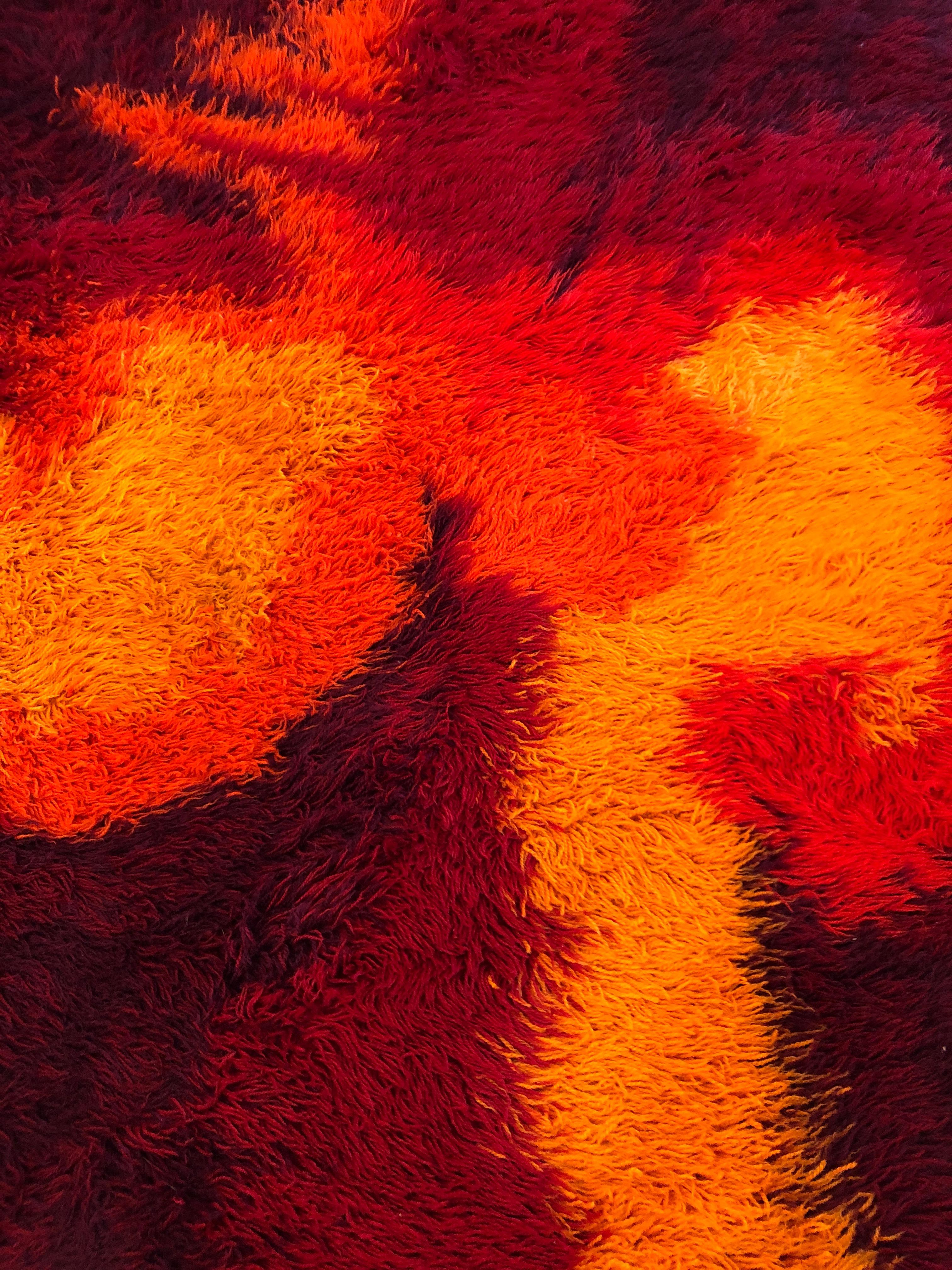 Sensational Scandinavian fire pattern shag rug by Ege Rya having a wonderful abstract design in a glorious blend of orange, yellow and deep burgundy.