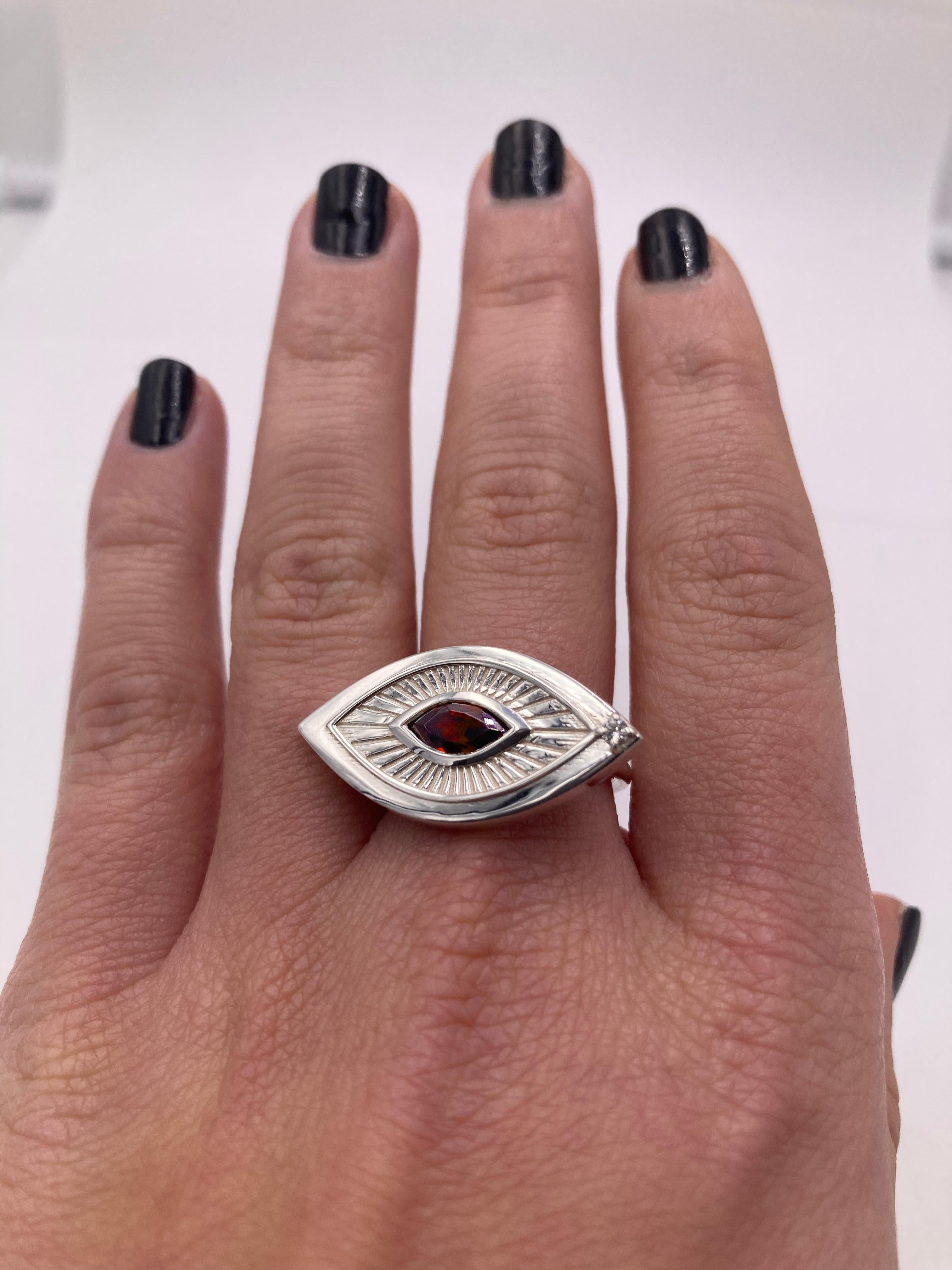 The Eye Shape Victorian Symbolist Ring in 18K white gold features a bold, handcrafted eye design with a deep red marquise-cut garnet at its center. 
Dimension: 0.98 in x 0.60 in (2,5 x 1,5 cm)
size 7 Usa Resizable.
Radiating outward from the garnet