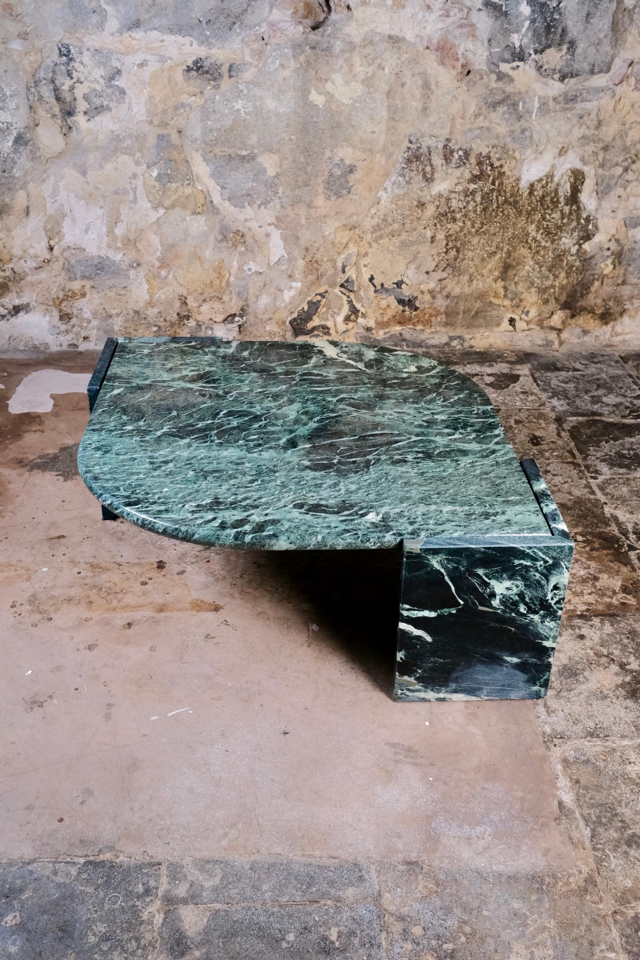 Eye-catching and rare, this emerald green marble coffee table was edited by Roche Bobois in France in the 1970s. Its distinctive eye-shape makes it a standout piece of French modern design. The tabletop and feet are separable, allowing for easier