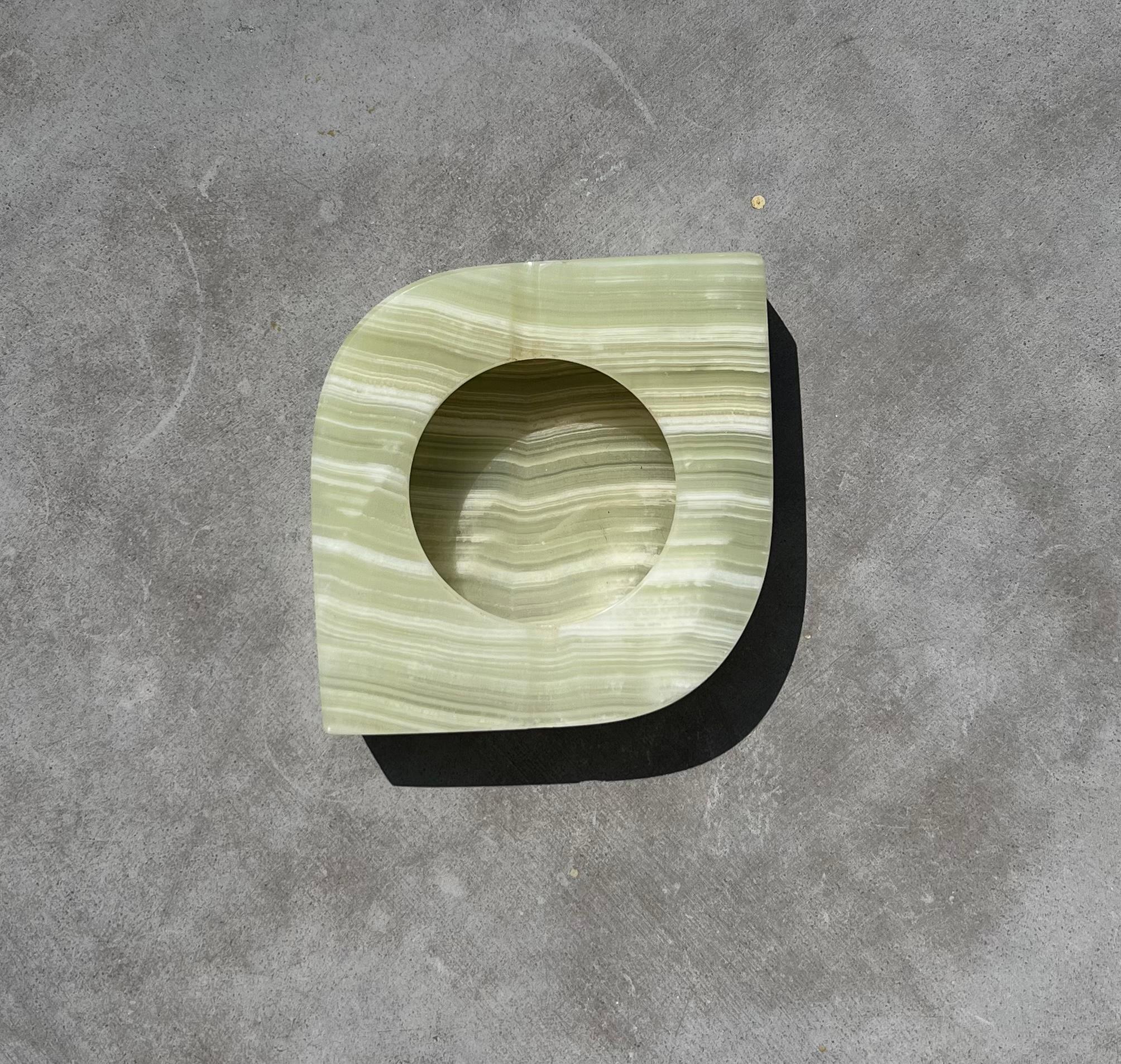 An eye-shaped onyx ashtray in pale pistachio, late 20th century. Immaculate condition. 
Dimensions: 
7” x 5.25” x 1.5”.