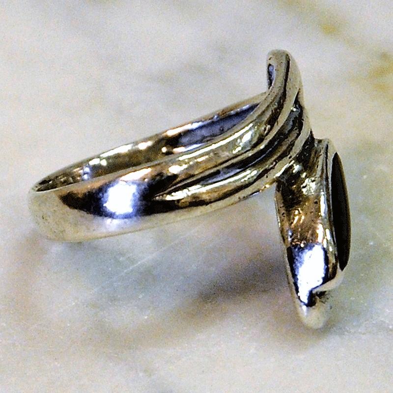 A beautiful silver ring with a brown eye shaped stone attached to a curvy and curly silver base. Modernism. Open airy section in front. Marked with 925.
Inner diameter is 19 mm, length of the 