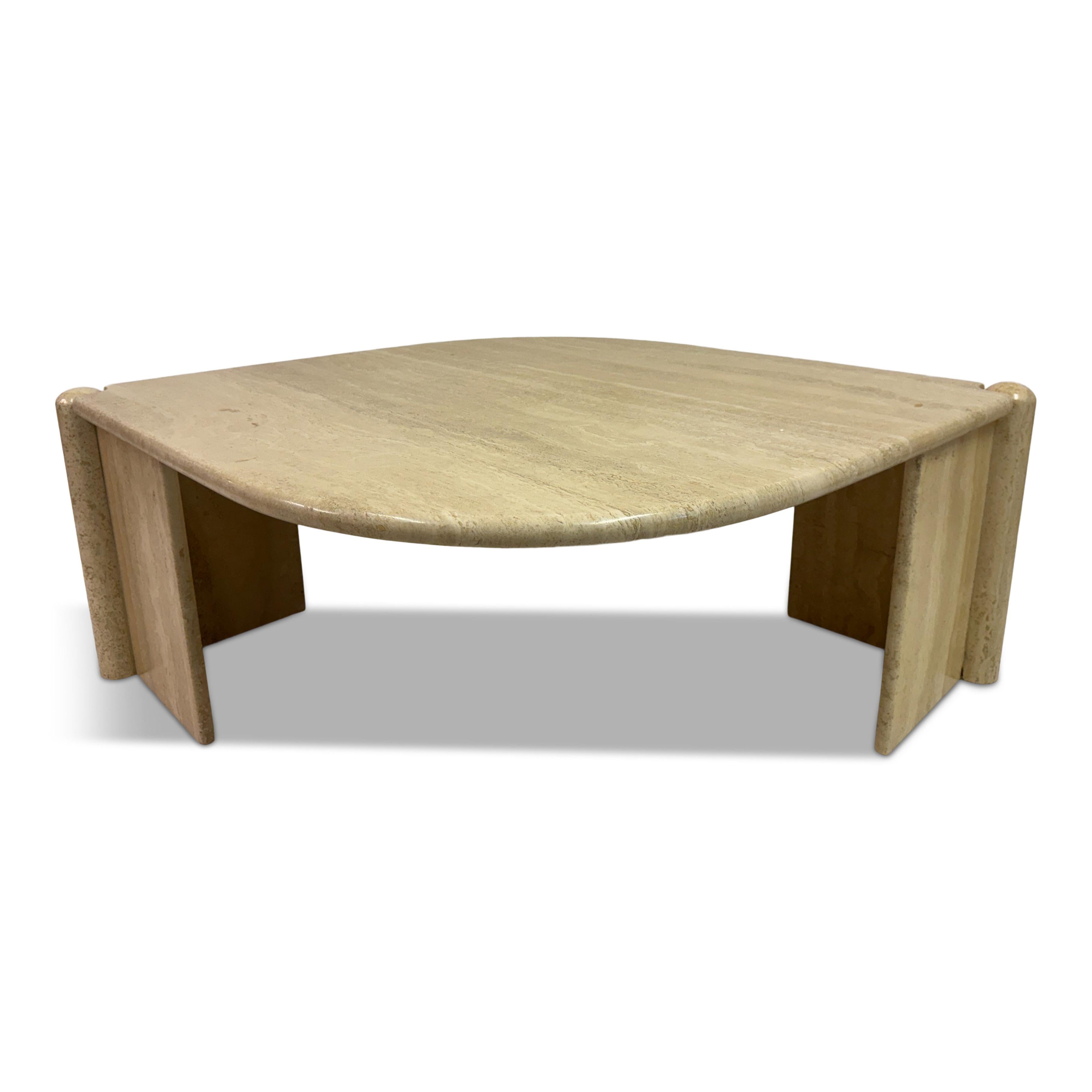 Eye-Shaped Travertine Coffee Table, 1980s


Elegant and sculptural travertine coffee table from the 1980s, featuring an unusual eye-shaped top resting on two thick slab legs with rounded outer edges. The soft curves and natural stone surface