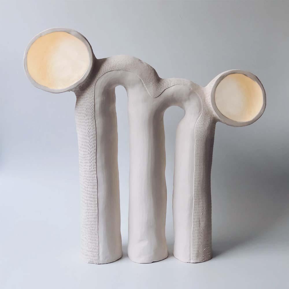 Explore this Eye table multi-light lamp inspired by natural creatures and designed by South African artist Jan Ernst. 

Jan Ernst is a multidisciplinary creative specializing in functional art and spatial design using clay as his main medium. The