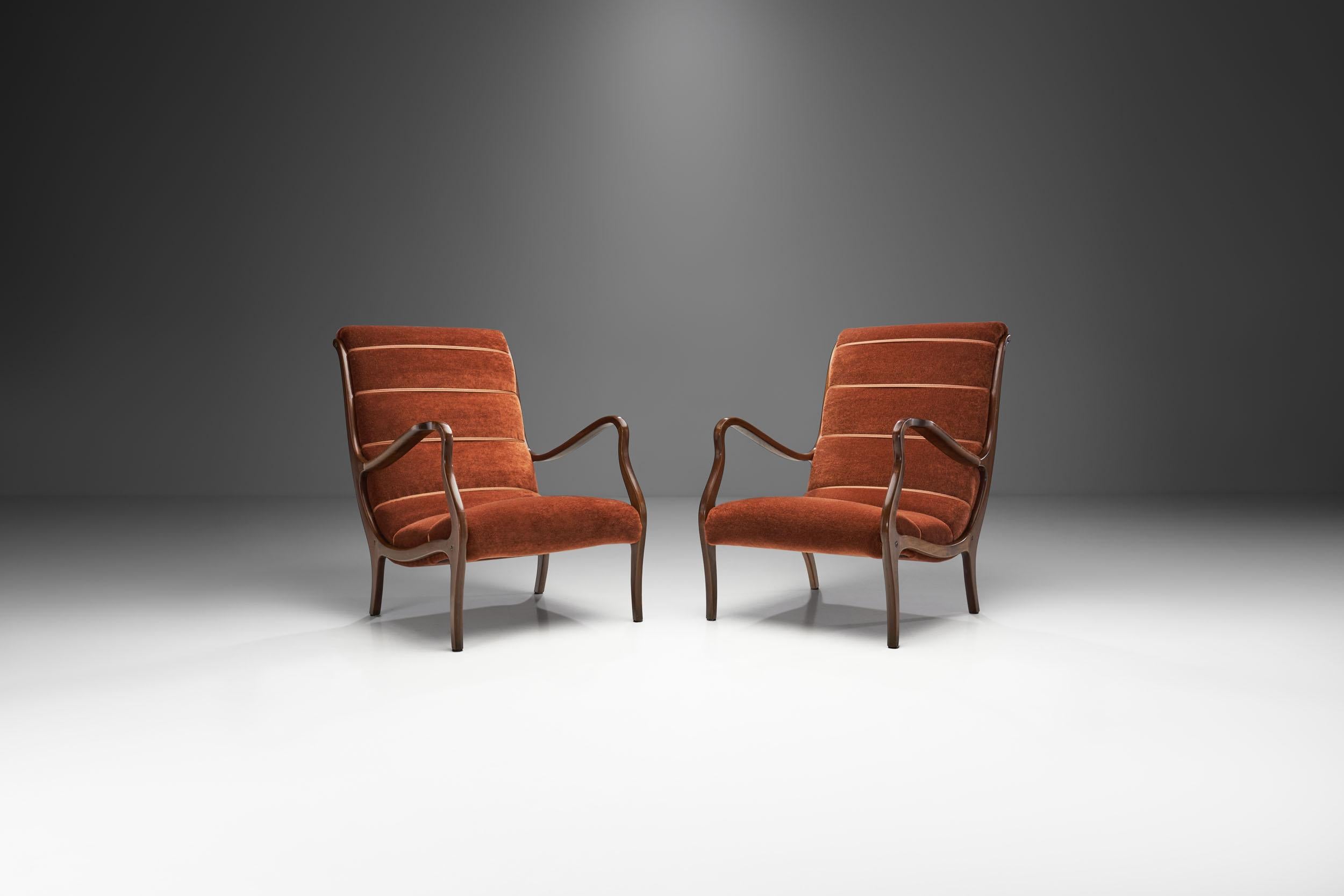 Like the 1958 Mitzi armchair, this model belongs to the most well-known chair designs of Italian designer, Ezio Longhi. This pair of lounge chairs takes one back to post-war Italy, when the now world-famous free form designs of the 1950s and 60s