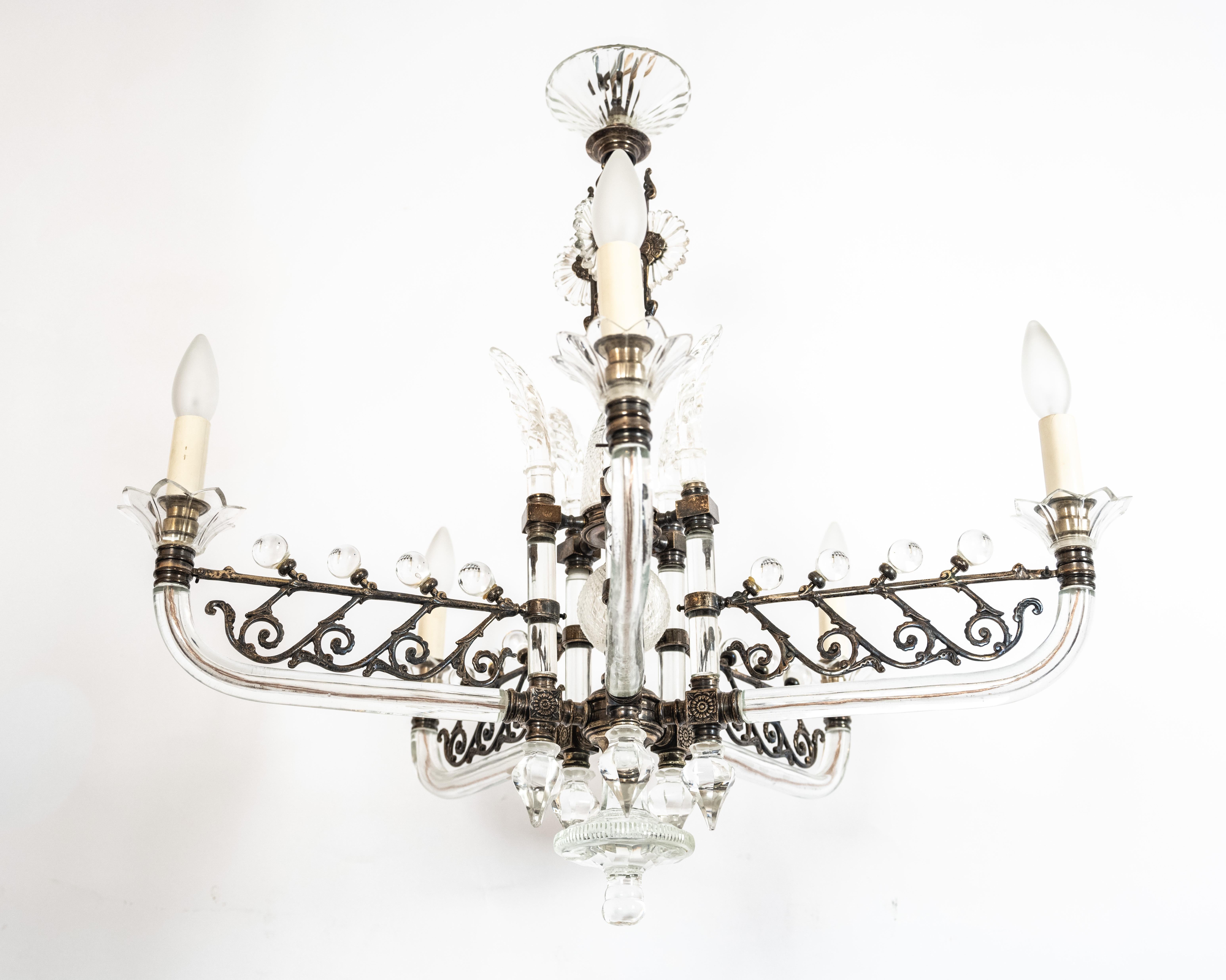 An Edwardian style chandelier by F&C Osler. Five silver embellished glass arms support candelabra sockets. Ornate silver lugs terminate in cut crystal elements. The center support features multiple cut crystal and cast glass elements. Silver