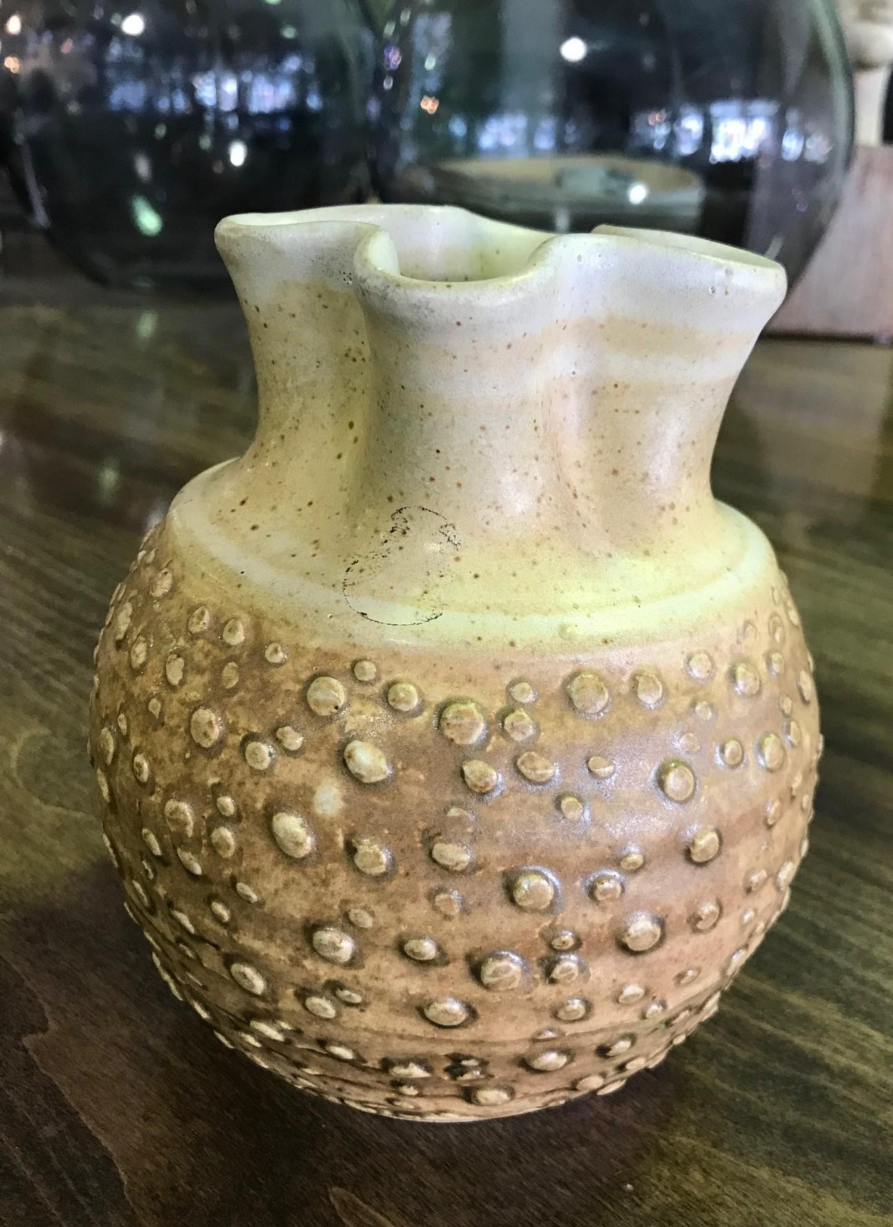 A wonderfully textured and designed, midcentury pottery vase by renowned master potter F. Carlton Ball.

Ball, who studied with Glen Lukens, taught at University of Southern California between 1956-1967 and later at University of Puget Sound,