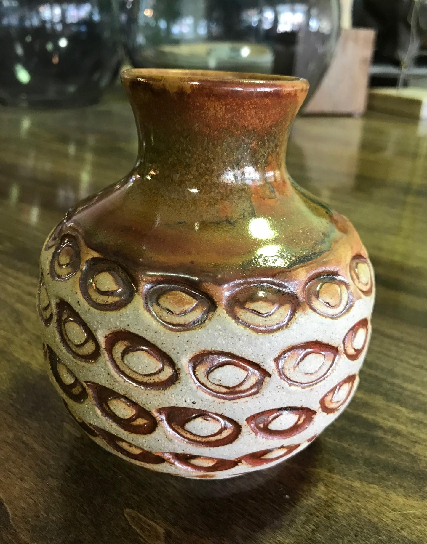 A fantastic, midcentury oval eye patterned pottery vase by renowned master potter F. Carlton Ball.

Ball, who studied with Glen Lukens, taught at University of Southern California between 1956-1967 and later at University of Puget Sound, Tacoma,