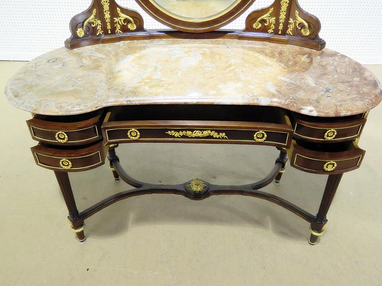 This is an outstanding Francois Linke style ladies vanity with a gorgeous slab of shaped Breche marble on top and adorned with crisp, Linke quality bronze ormolu and bronze acorn mounts. The mahogany case is designed in a kidney shape and is
