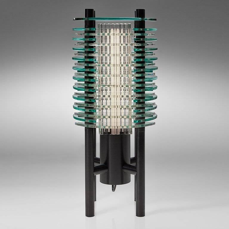 Create a bold statement with this table lamp, titled F-Stop, designed and created by Sidney Hutter Glass & Light. Originally designed in 1988, this work of art stands the test of time making a bold statement in today's contemporary setting. The lamp