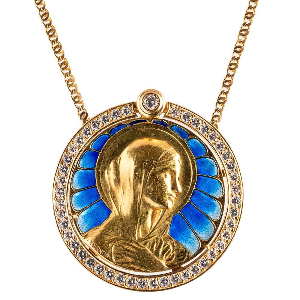This beautiful pendant featured an image of the Virgin Mary, a golden halo encircling her head as light streams from streaks of blue plique-a-jour enamel. The pendant is signed F. Vernon and made of 18 karat yellow gold circa 1905. The mounting and