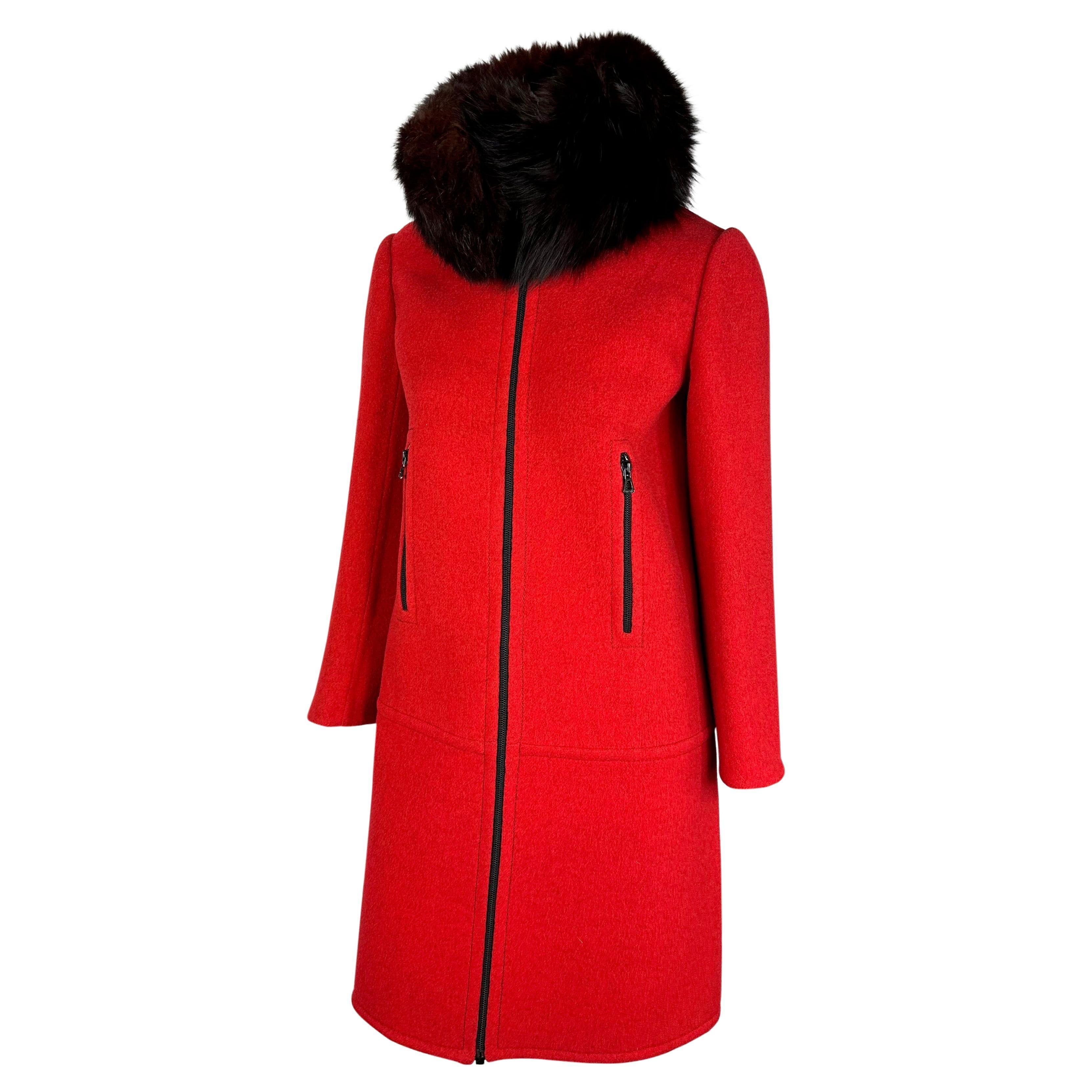 Presenting a fabulous red Christian Dior Haute Couture coat designed by Marc Bohan. From the Fall/Winter 1969 collection, this incredible jacket is complete with zipper closures at the front and hip pockets and a black-red fox fur collar.