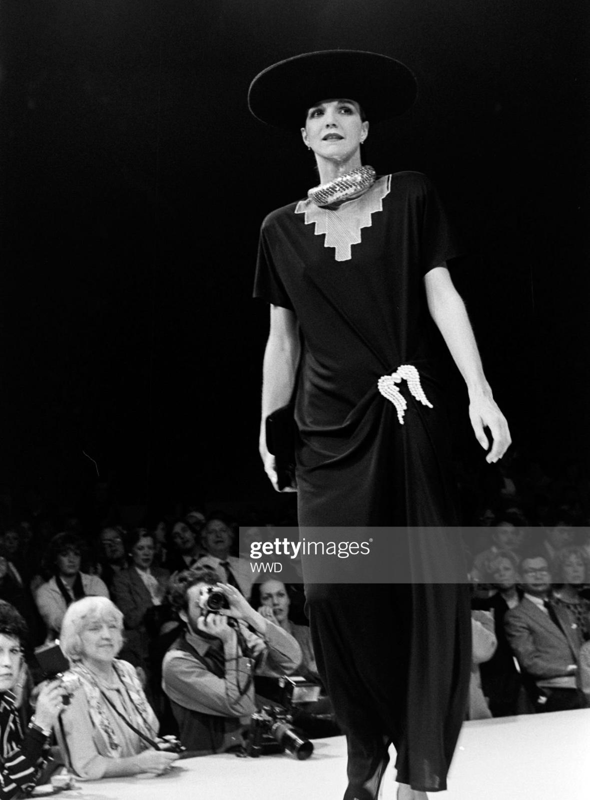 Presenting a beautiful black crêpe de chine Chloé gown, designed by Karl Lagerfeld. From the Fall/Winter 1979 collection, this short sleeve gown debuted on the season's runway. This lightweight, semi-sheer gown is made complete with a beige angular
