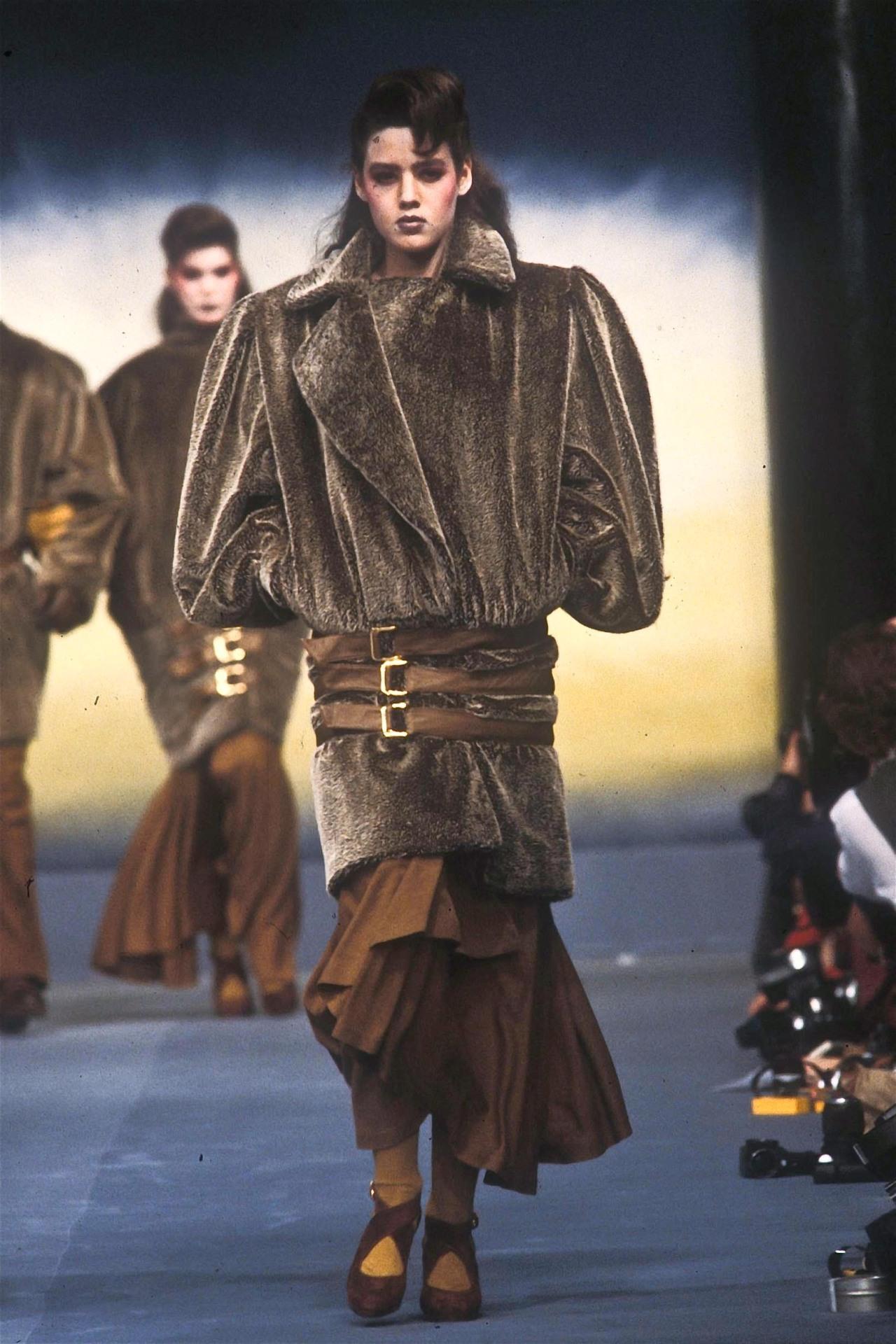 Manfred Mugler designed this brown oversized faux fur jacket for the Fall/Winter 1983 Thierry Mugler collection. Similar brown faux fur coats with leather accents were featured on the season's runway. Constructed entirely of faux fur, this