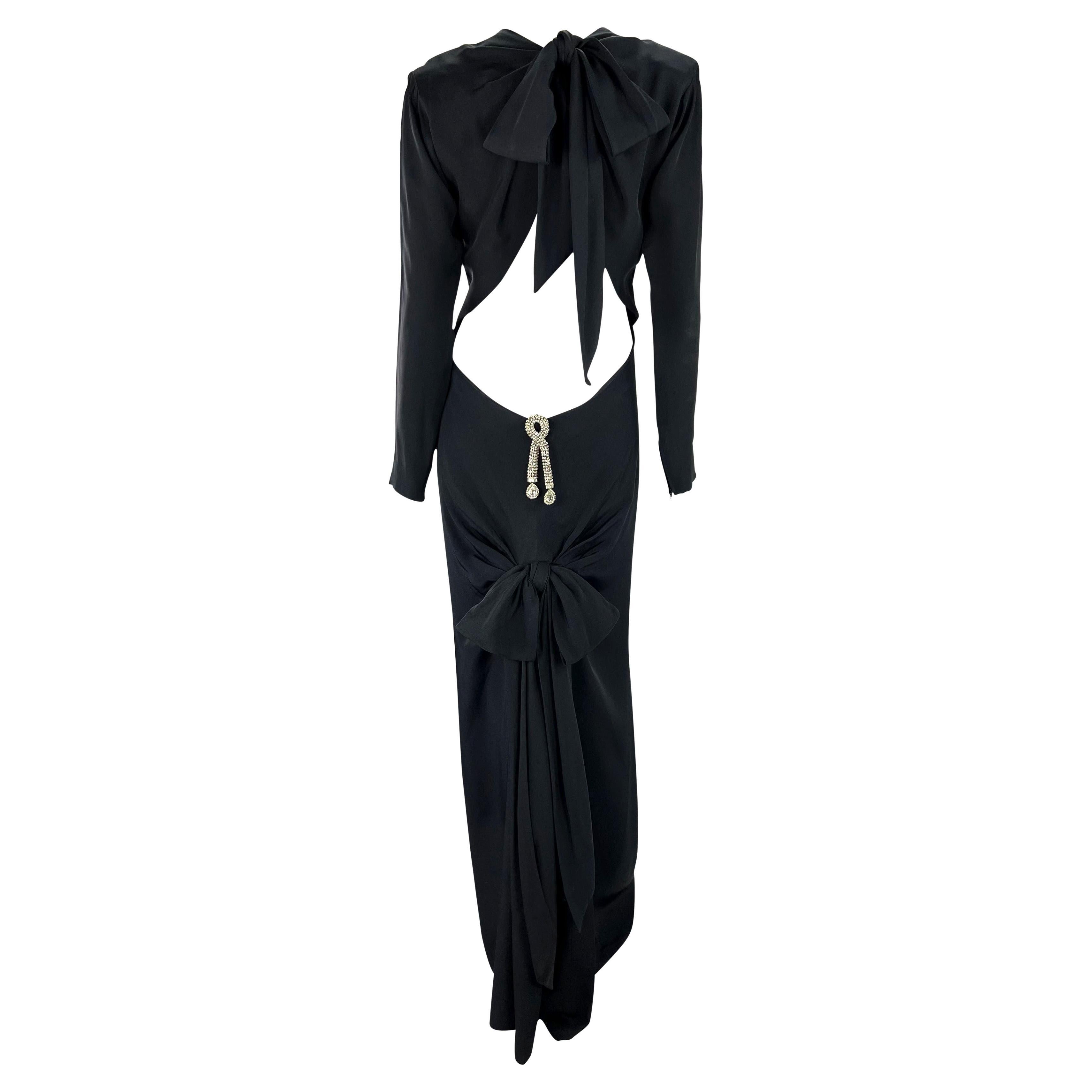 This stunningly sensual black haute couture evening gown was designed by one of the true masters of 20th century couture, Yves Saint Laurent. Designed by YSL for his  Fall/Winter 1983 Haute Couture collection, this gown is paired down and chic from