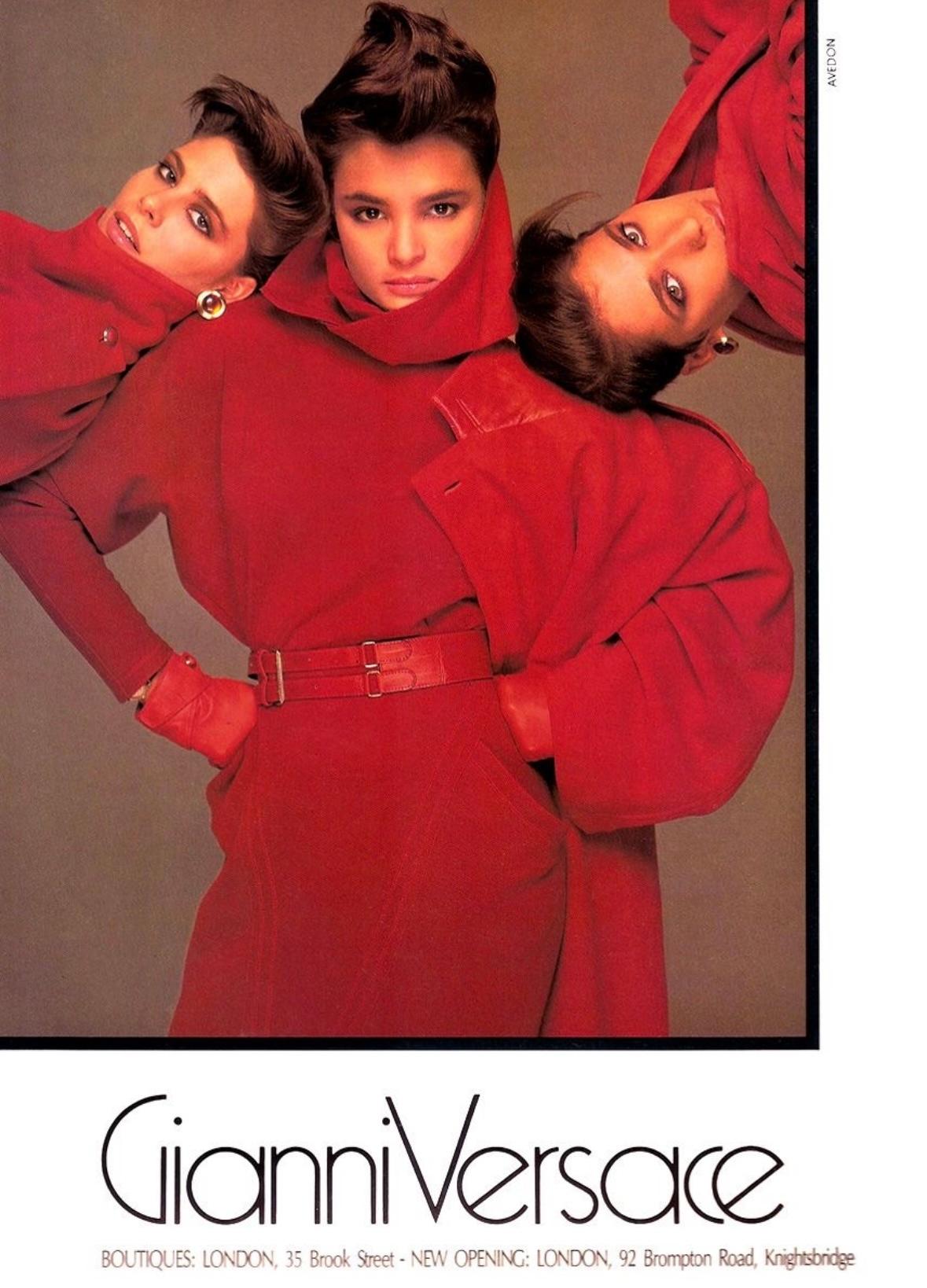 This Gianni Versace red bodycon knit wool scarf dress is from the Fall/Winter 1984 collection. Designed with a sleek, long-sleeve silhouette, it features an integrated draped scarf detail at the neckline. This piece was highlighted in the season’s