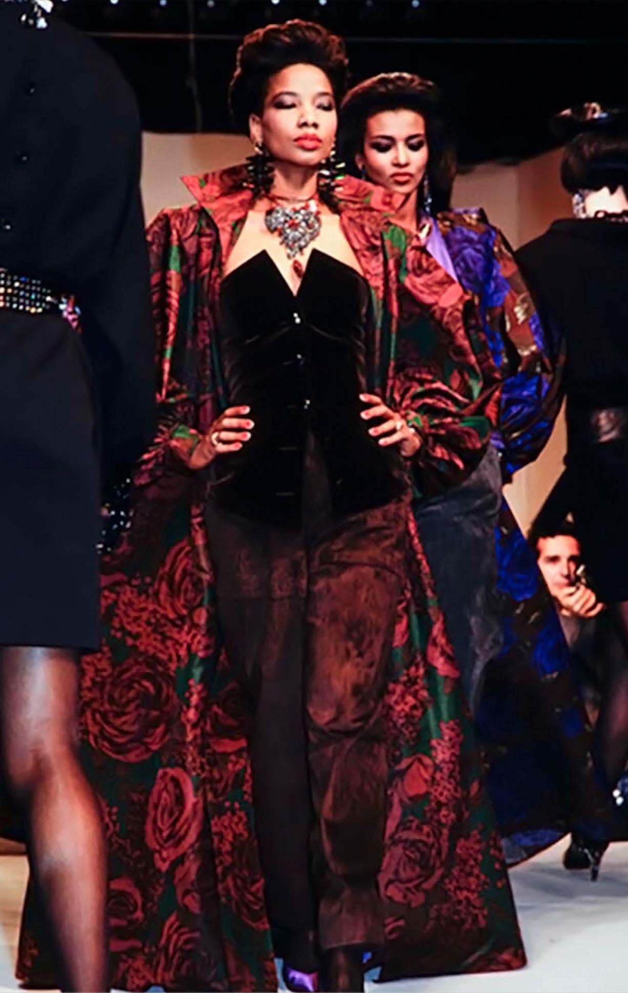Dalla collezione Saint Laurent Autunno/Inverno 1985 di Yves Saint Laurent, questo top senza spalline è realizzato in morbido velluto nero e presenta una silhouette ispirata al corsetto con vita scolpita e scollatura angolare senza spalline. Il pezzo