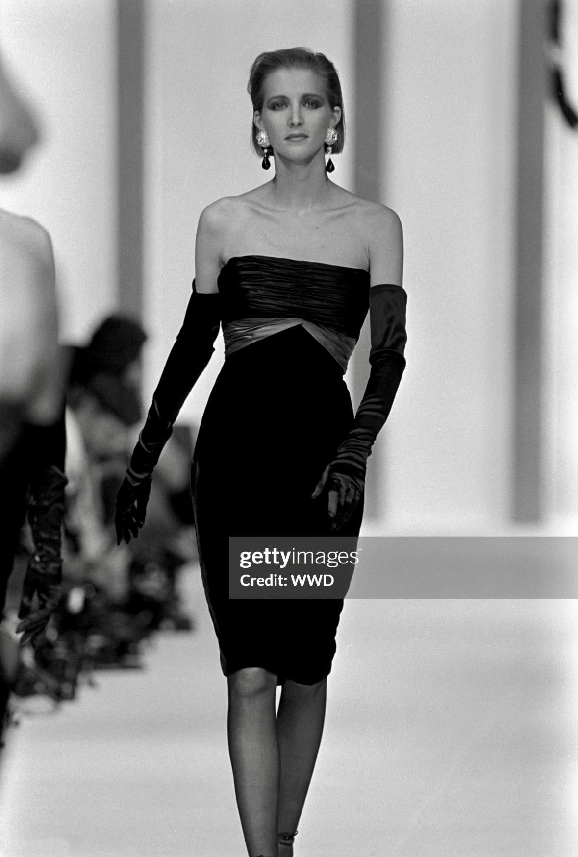 From the Fall/Winter 1985 collection, this elegant strapless Valentino dress debuted on the season's runway. This chic dress combines black and white silk ruching that drapes gracefully around the bust, accented by a perfectly placed bow at the