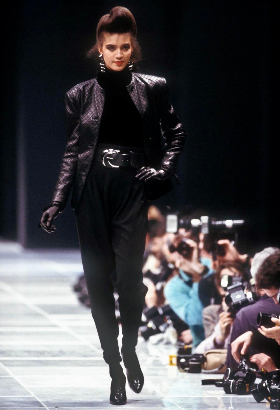 Presenting a beautiful black leather embroidered Gianni Versace skirt set, designed by Gianni Versace. From the Fall/Winter 1986 collection, this jacket from this set debuted on the season's runway. The set consists of a quilted collarless leather