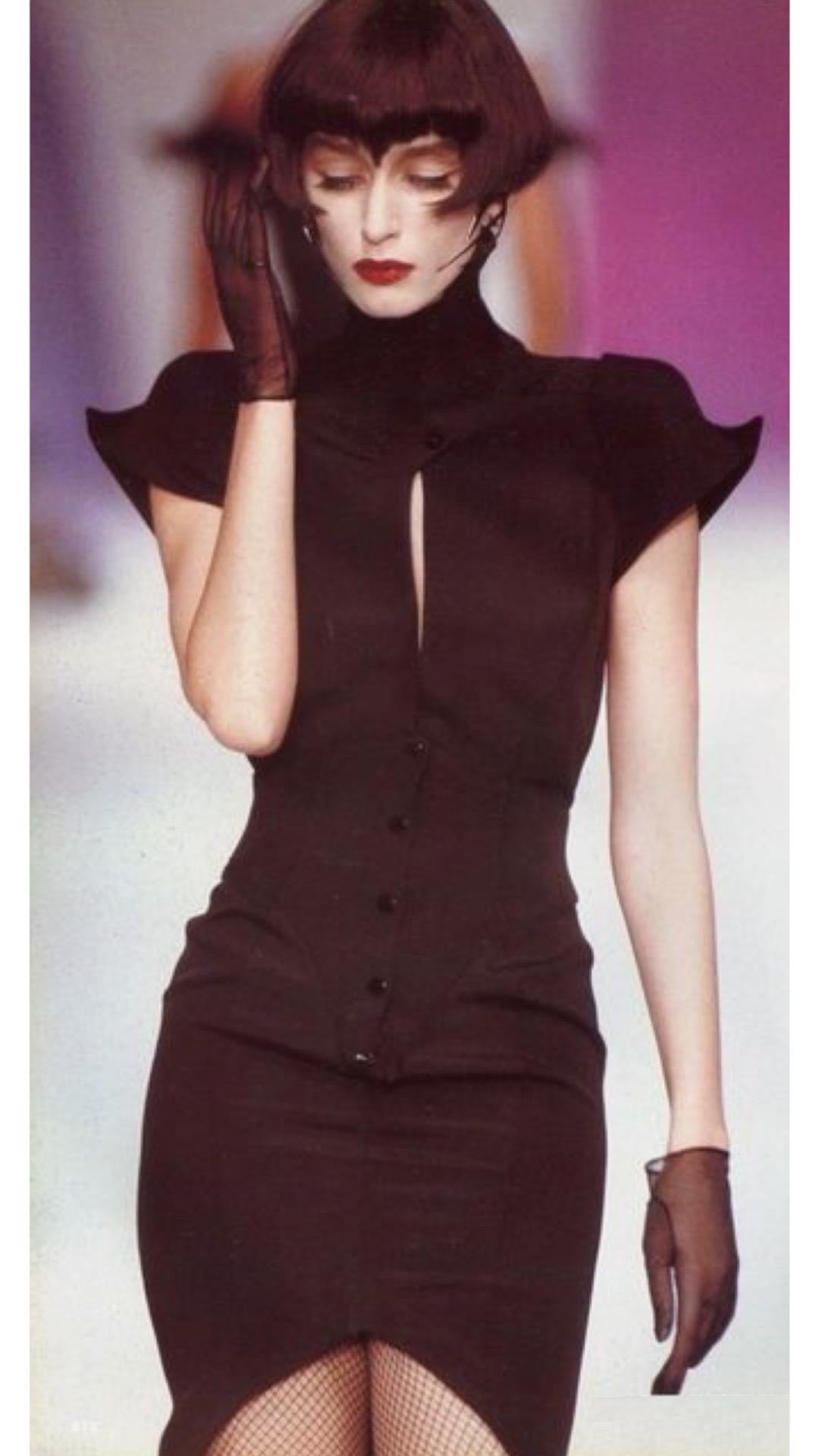 Add edge and drama your wardrobe with this Thierry Mugler sculptural dress from the Fall Winter “Les Infernales” 1988 collection and seen on the runway. This dress features a tall standing collar, zigzag jagged design at the chest, rounded shoulders