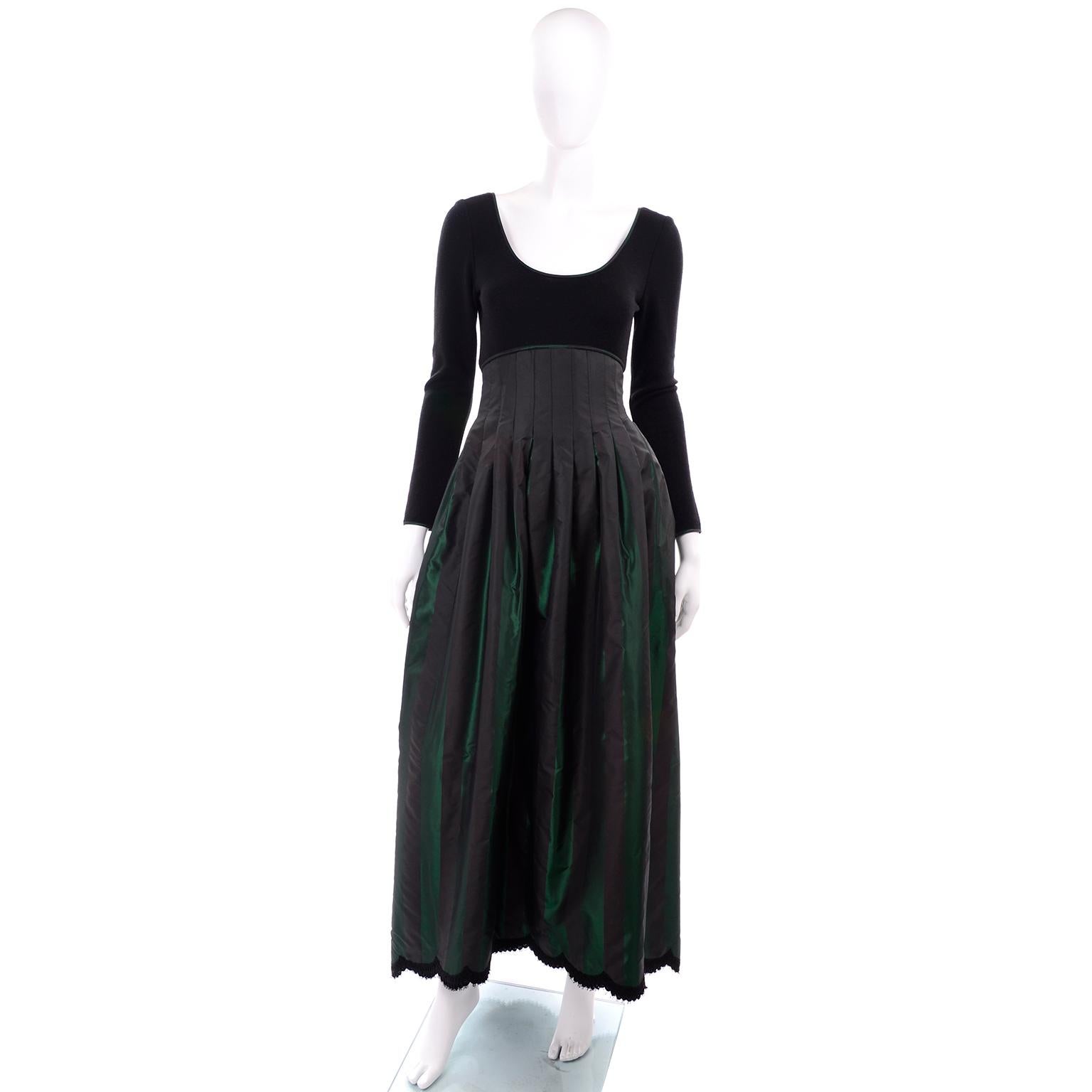 This is a stunning vintage 1980's Geoffrey Beene evening gown with a black wool knit bodice and a long skirt with an ultra high waistband in black and green striped iridescent pleated taffeta skirt with lace trim on the hem. This dress is important
