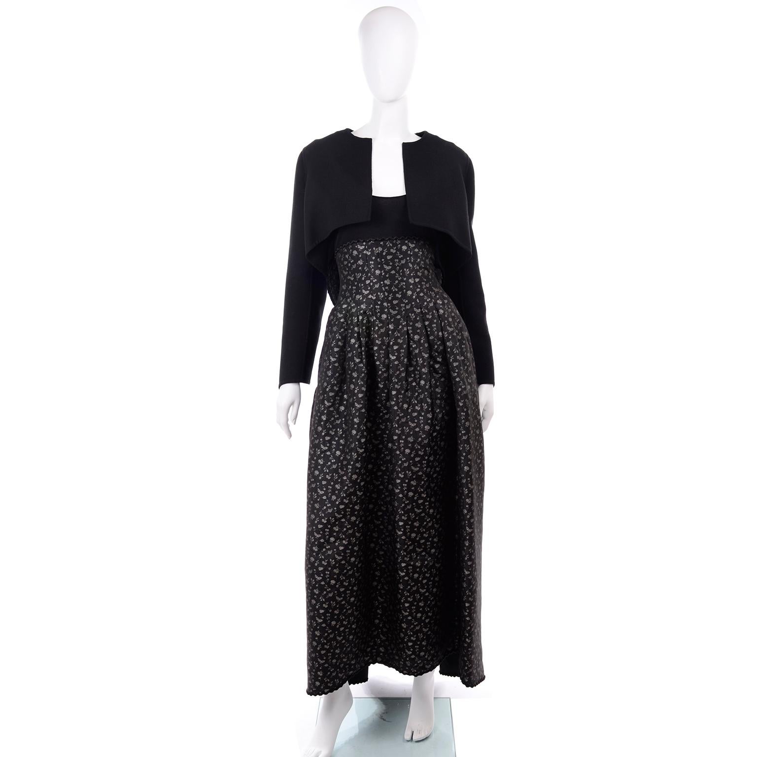 This is an archival Geoffrey Beene vintage outfit from the 1980's that includes a long dress and a bolero style jacket with tassels.  The dress has a solid black knit bodice with long sleeves with hook and eye & zipper closures, a scoop neck and a