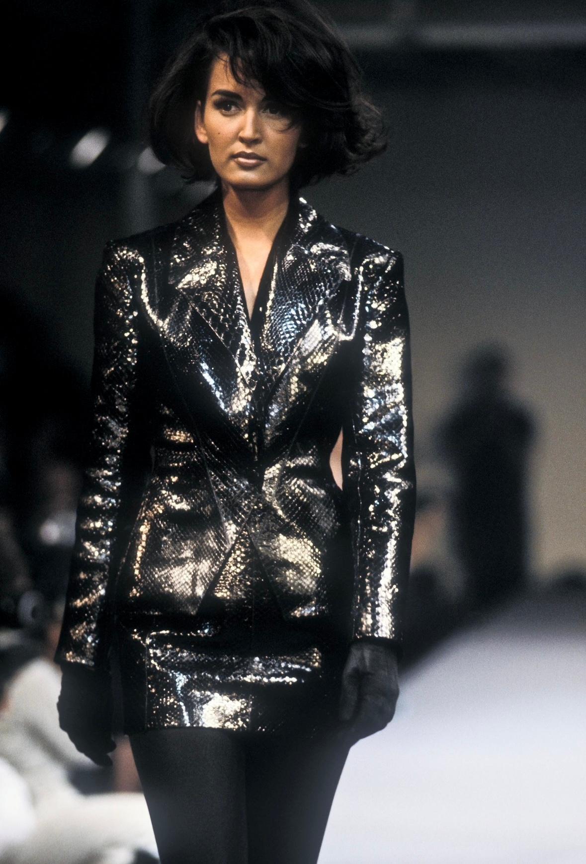 Dalla collezione Autunno/Inverno 1990, una versione di questa minigonna in pitone nero lucido di Alaïa ha debuttato sulla passerella della stagione come parte del look 60, con la modella Gail Elliott. Realizzata interamente in pelle di pitone nera
