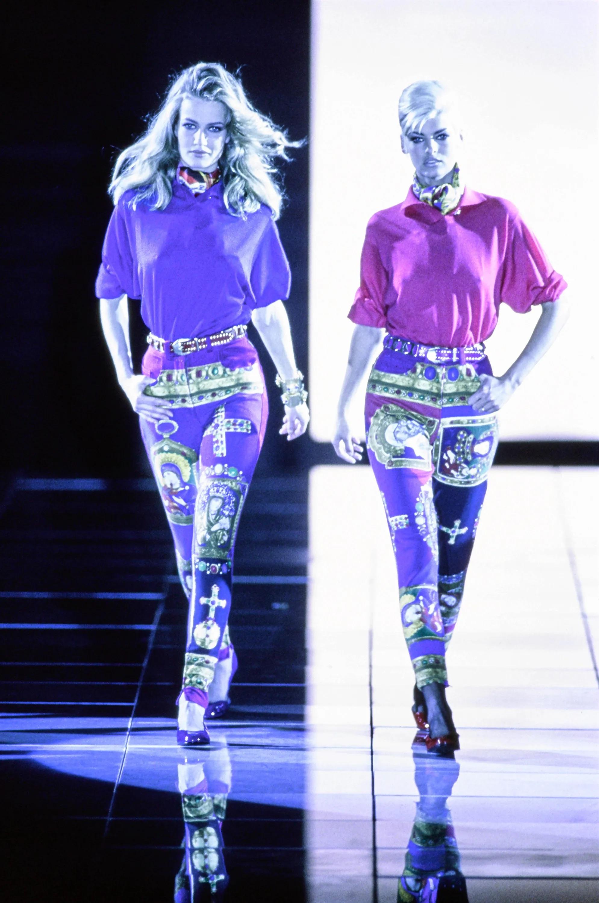 Presenting a pair of multicolored Roman Catholic-inspired denim pants by Gianni Versace, designed by Gianni Versace for the Fall/Winter 1991 collection. These denim pants made their debut on the season's runway, showcased by Linda Evangelista, and